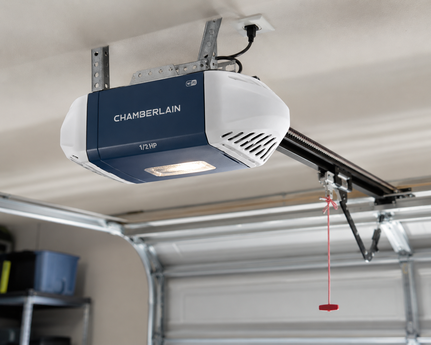 Garage door opener mounted on the ceiling with a red pull cord hanging down.