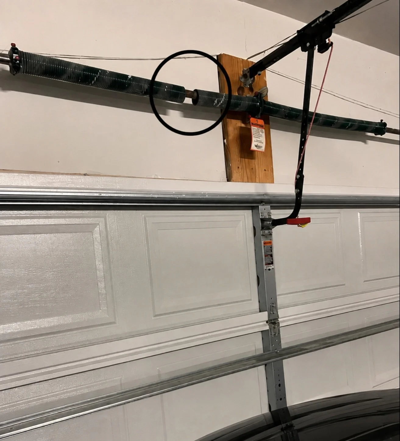 Broken garage door torsion spring on a Kansas City home before repair