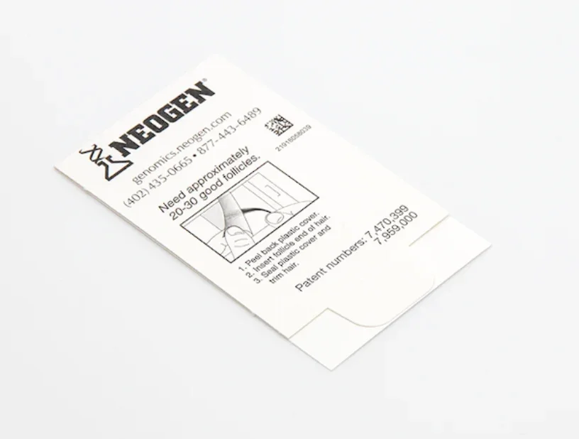 A small white instruction card with black text and a diagram for using a Neogen hair follicle cap, including patent number and contact information.