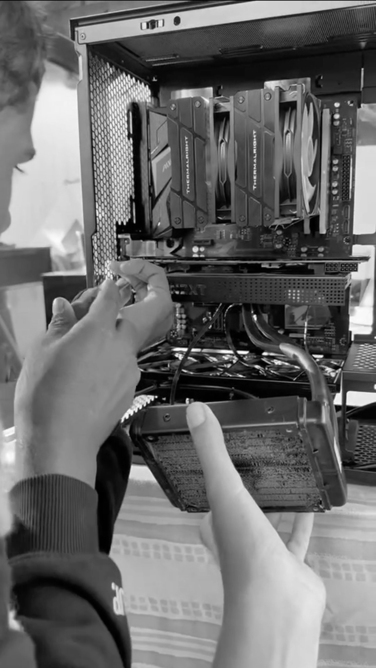 People installing a graphics card in a computer case.