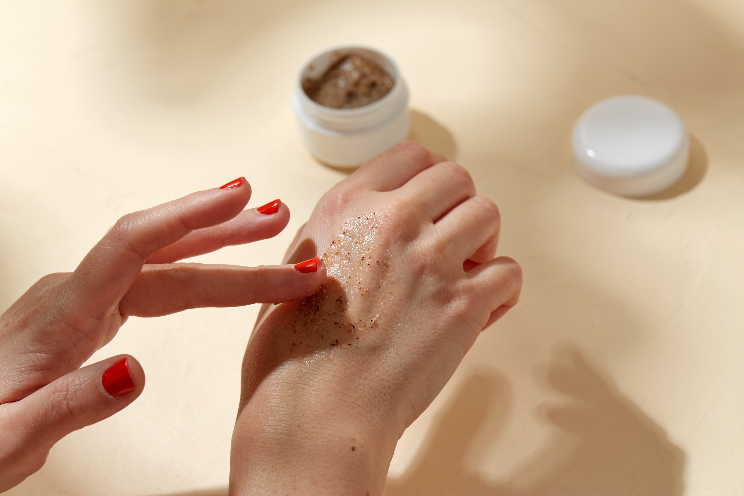 close up hands applying natural scrub skin.jpg