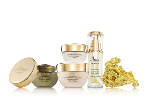 Collection of skincare products including jars and bottles, with a gold-colored sponge or buff.