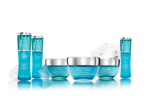 A collection of skincare products, including bottles and jars labeled 'Aqua for Normal to Combination Skin,' 'Replenishing Night Cream,' and 'Optima Hydration Day and Night Creams,' with ice cubes in the background.