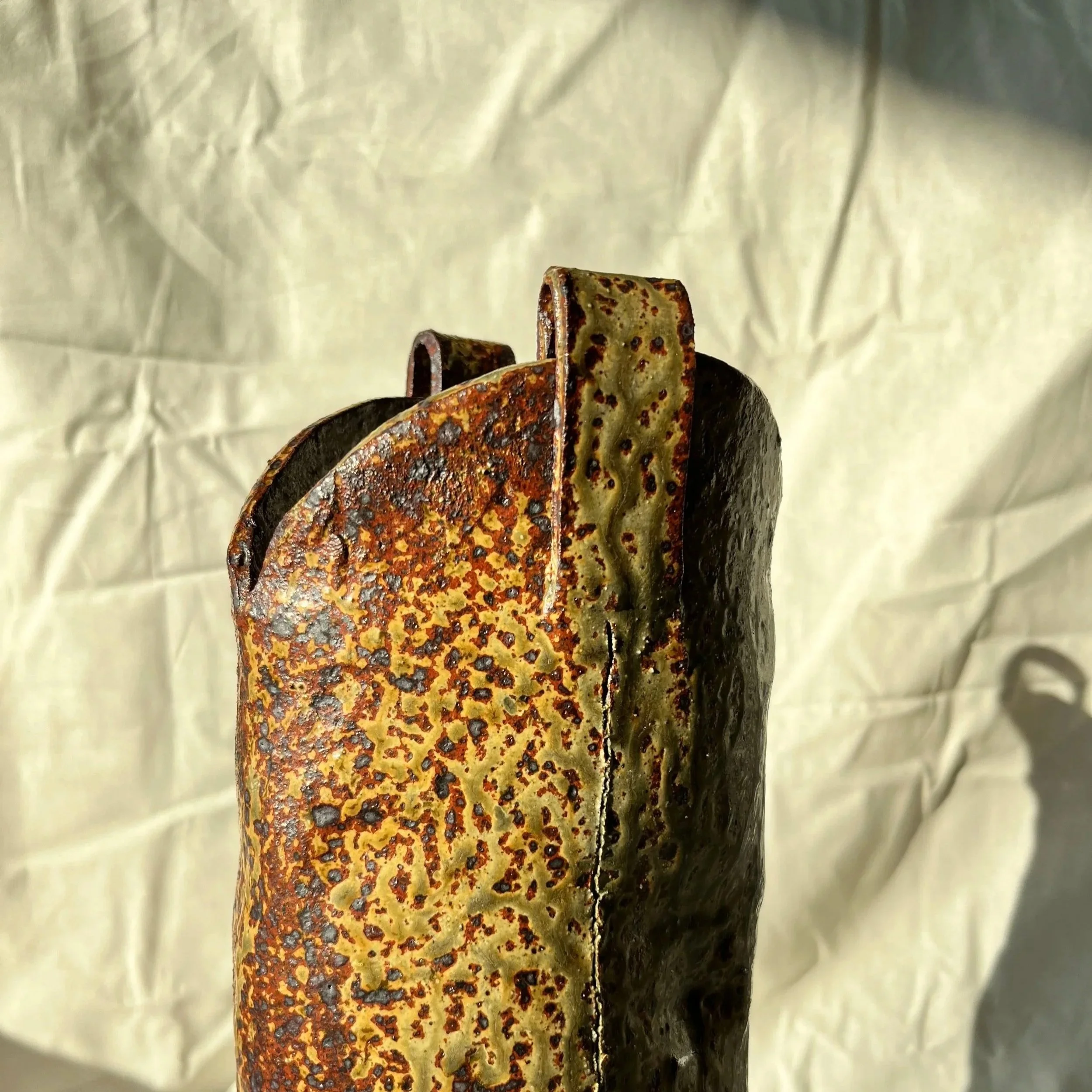 Close up of a hand built ceramic cow boy boot designed in Melbourne