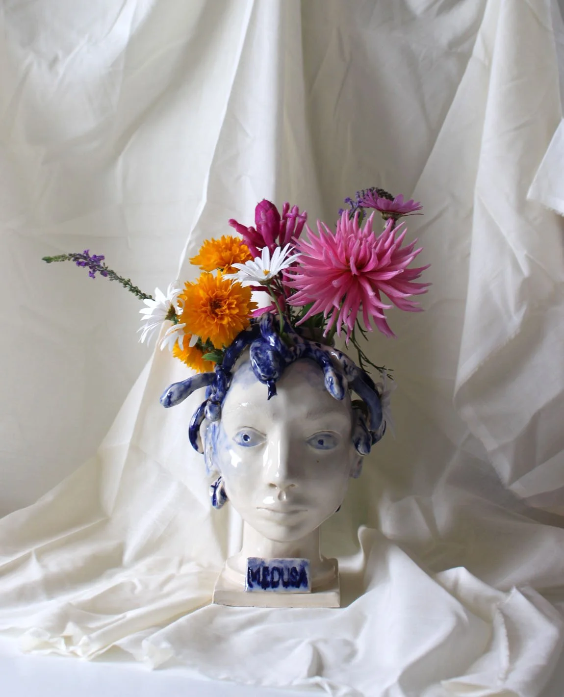 Hand sculpted ceramic Medusa head vase with blue colbalt oxide painted snakes