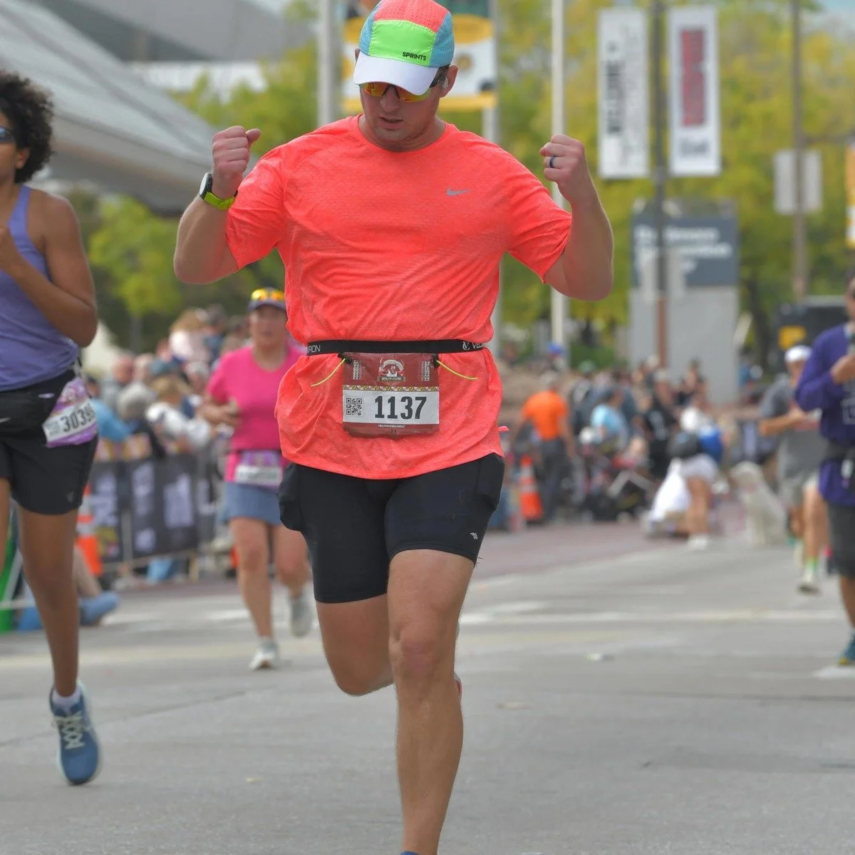 John Dale running through the finish of the 2025 Baltimore Marathon.