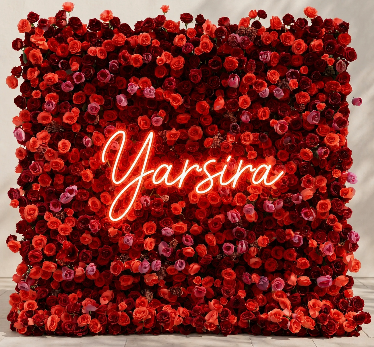 A wall decorated with deep red and pink roses.