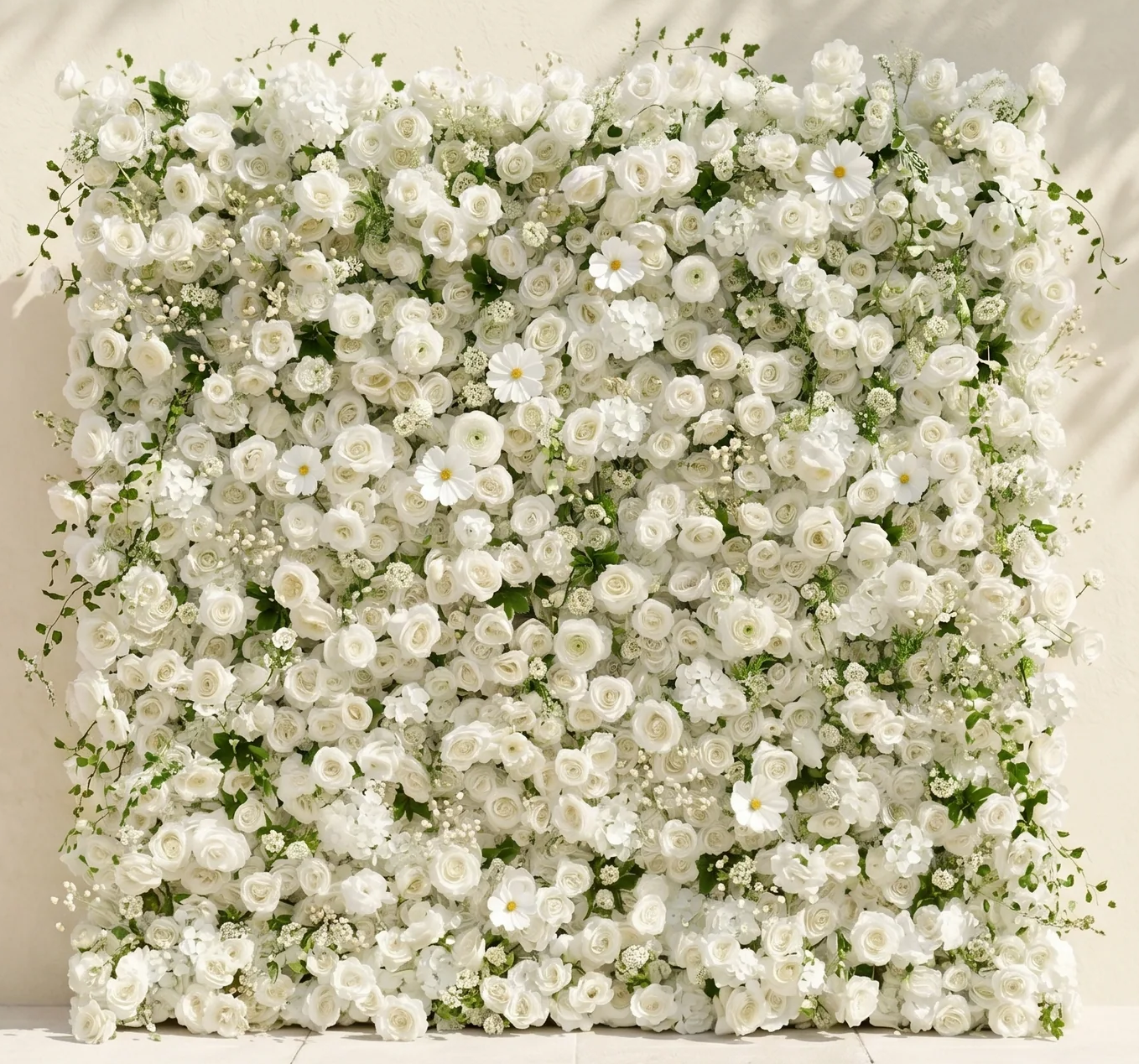 A large floral arrangement of white roses, daisies, and other white flowers with green foliage.