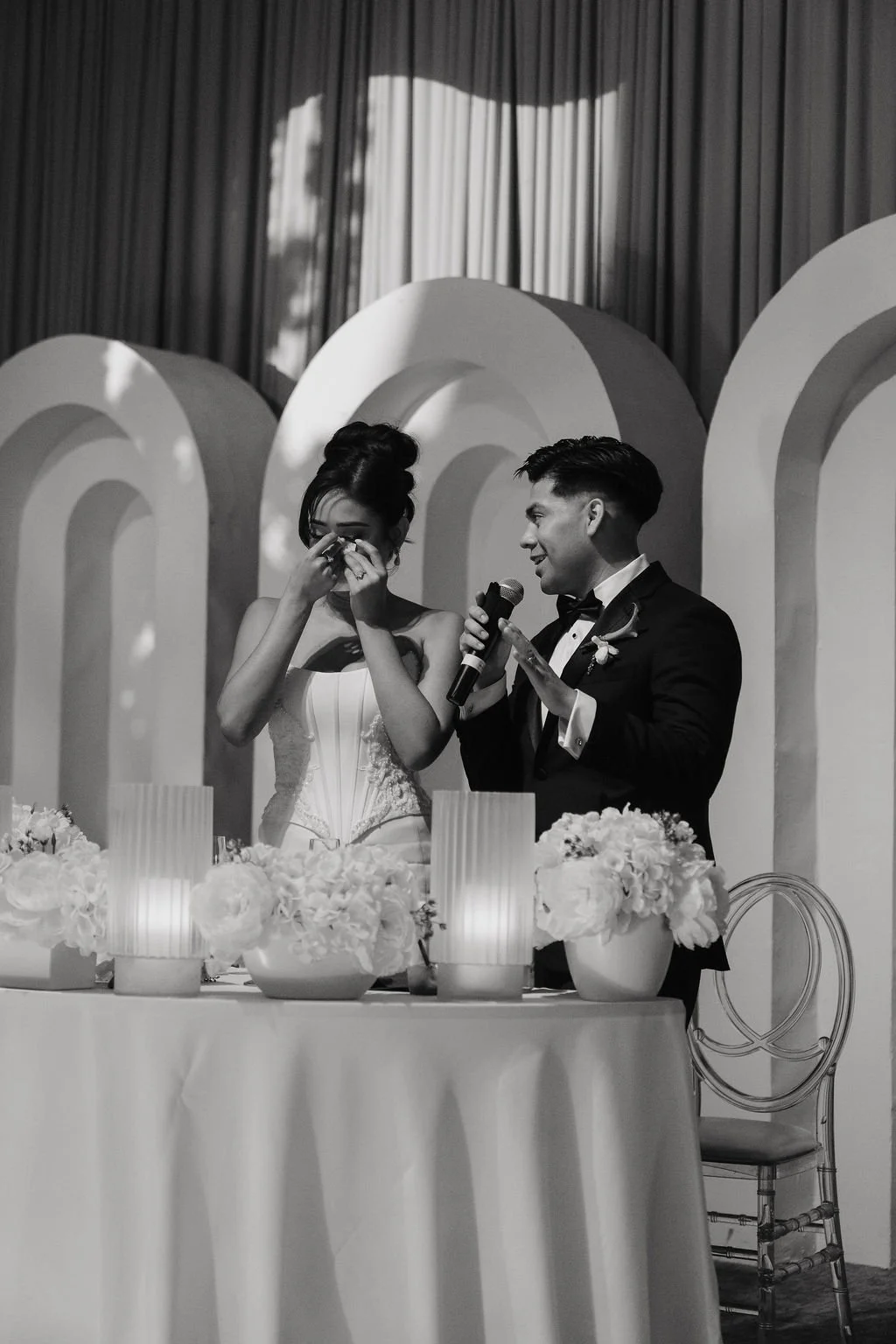 Bride and groom seated together at their sweetheart table during an elegant Las Vegas wedding reception.