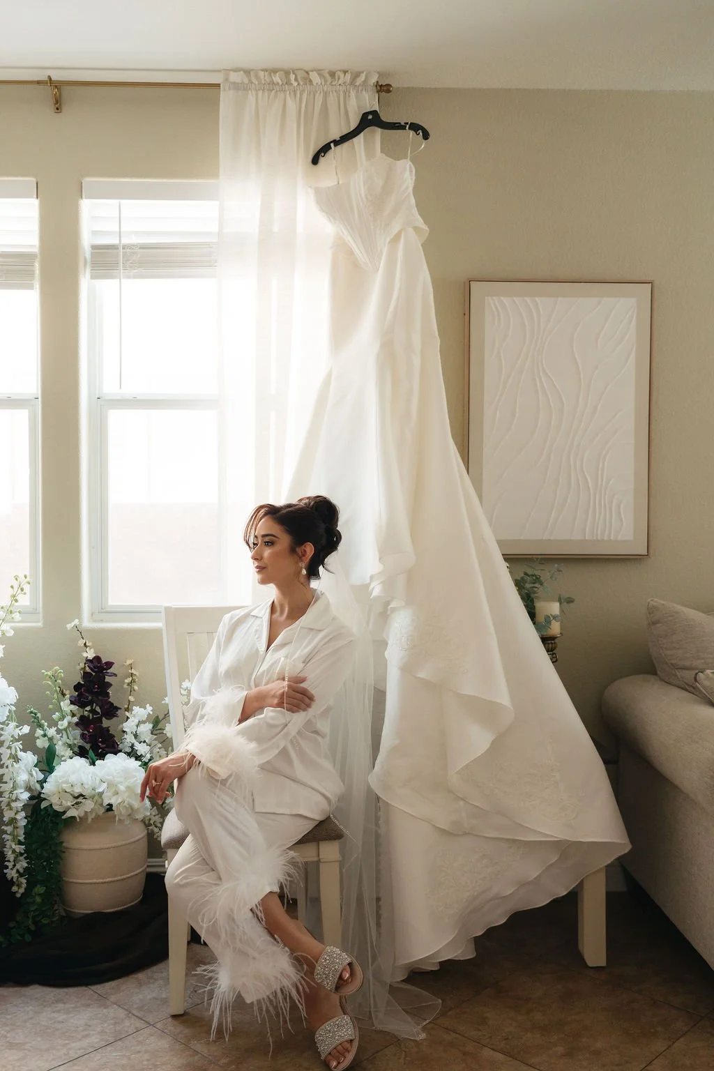 Bride posing with her bouquet and flowing wedding gown beside classical columns in Las Vegas.