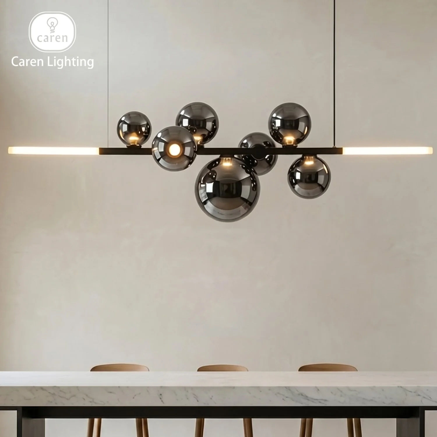 Modern black chandelier with multiple reflective spherical bulbs hanging over a white marble table with wooden chairs.