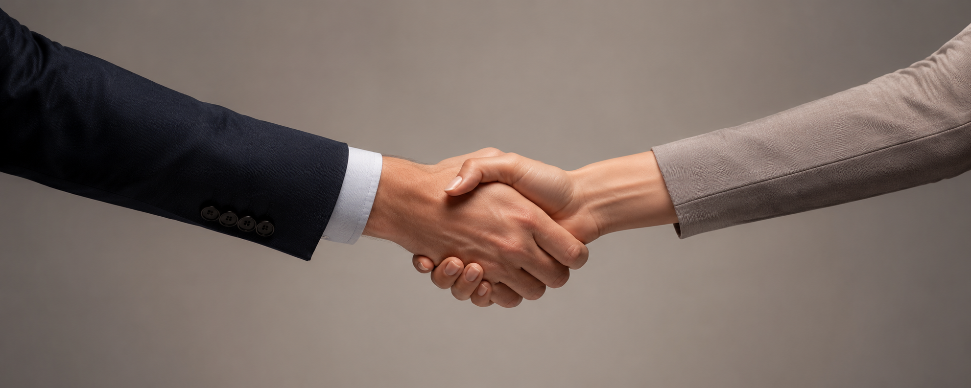 A close up picture of a handshake between a man and a woman.
