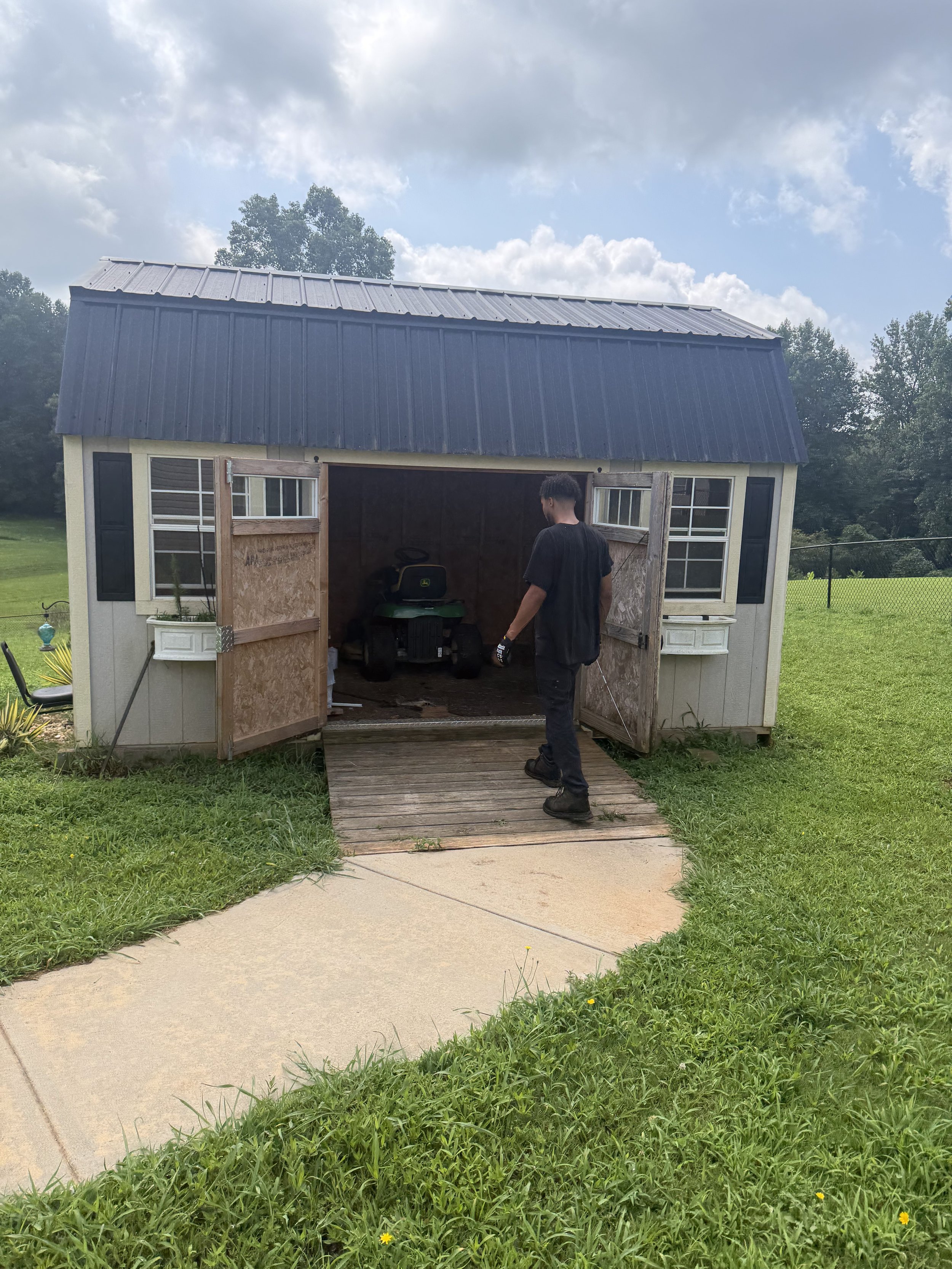 Old backyard shed being cleared out before demolition and removal in Hall County, GA