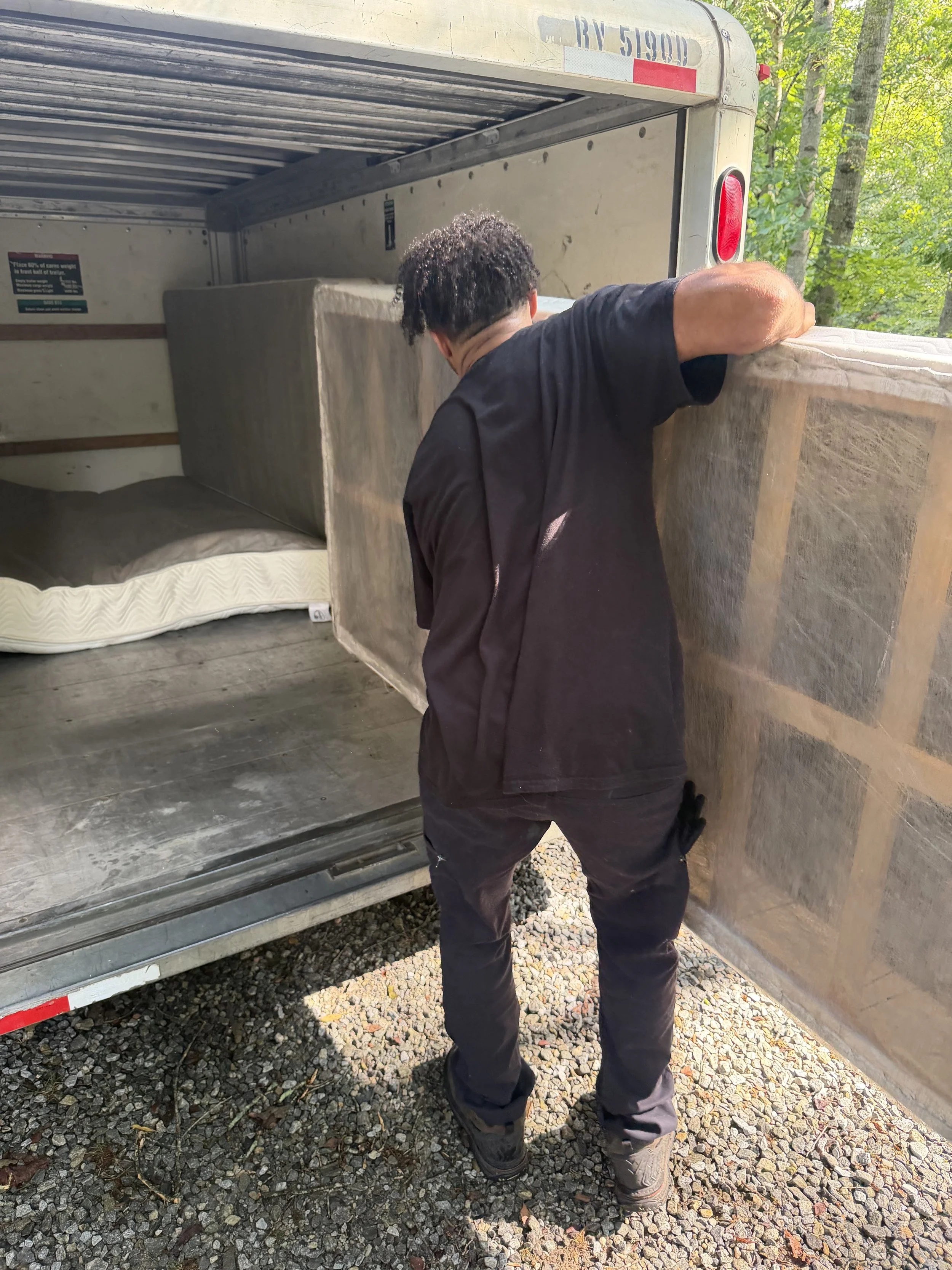 No Pain Junk Removal loading a mattress into the trailer during an estate cleanout in Hall County, GA
