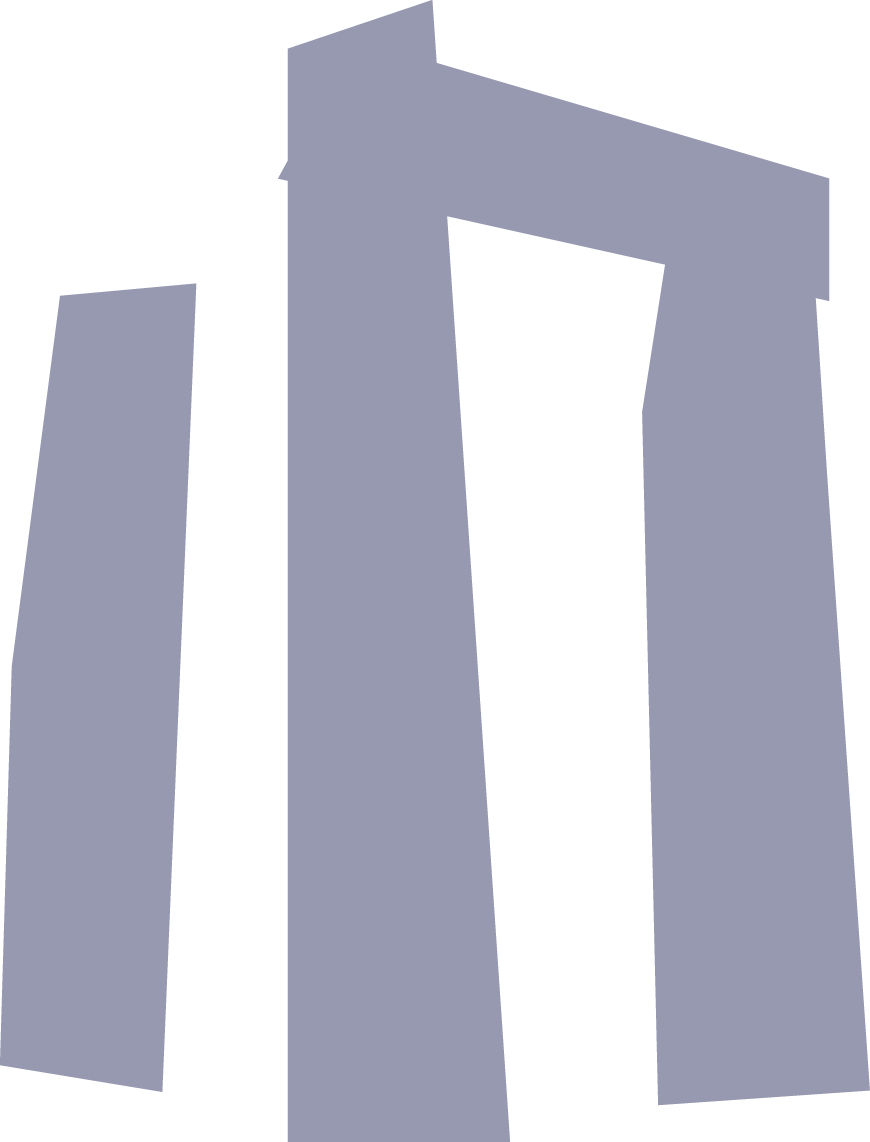 A low-angle view of large, rectangular, stone-like blocks arranged vertically, resembling a modern architectural structure or sculpture.