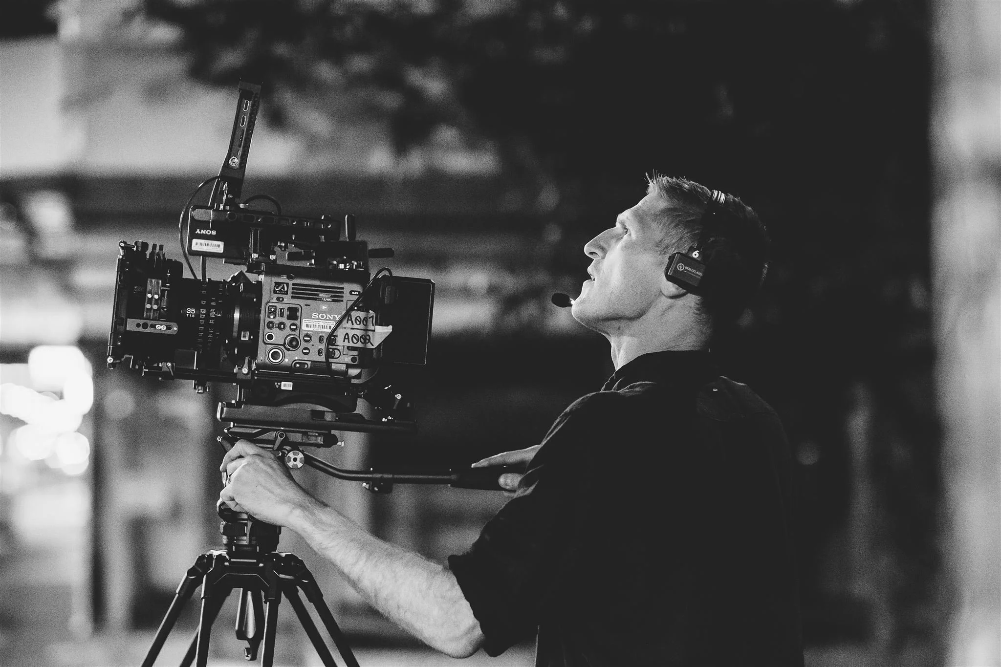 Behind-the-scenes photo of Jerome Cole working as director of photography, operating a cinema camera on set.