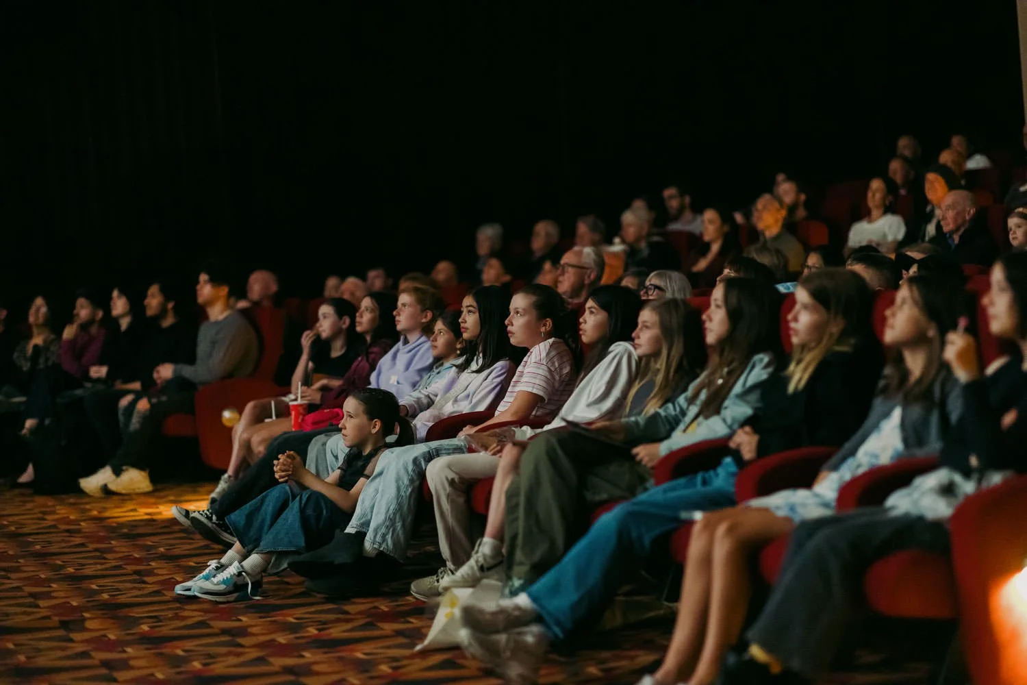 Audience at the Palace Cinemas screening of Things Will Be Different, seated in a dark theatre watching the film.
