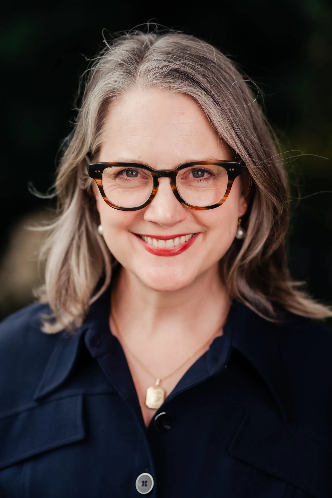 Portrait of Dr Laurel Moffatt, Principal of Mary Andrews College, photographed outdoors against soft greenery.