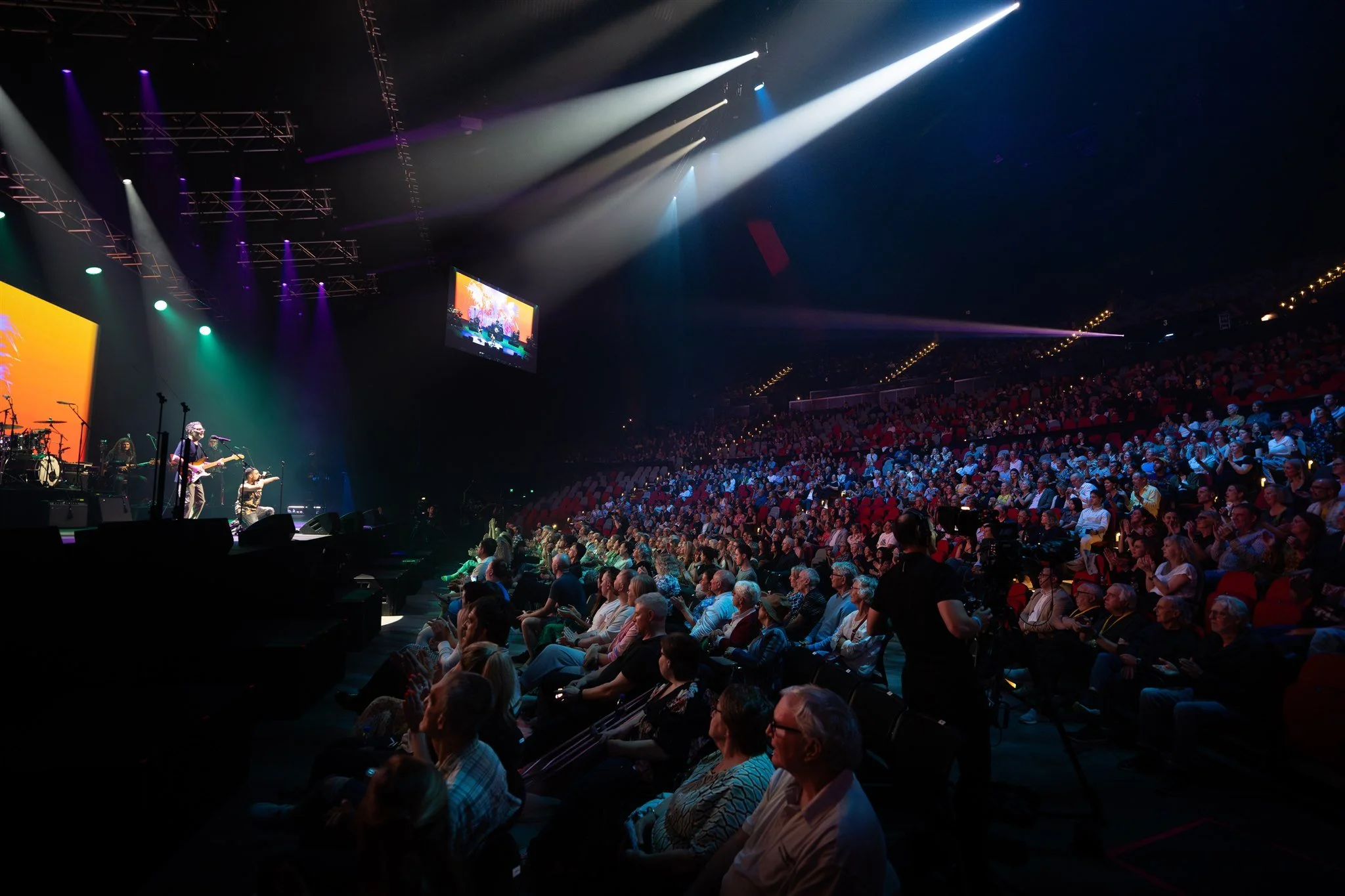 Emmanuel Kelly performing at an OzHarvest charity concert, broadcast live on television in front of a large live audience.