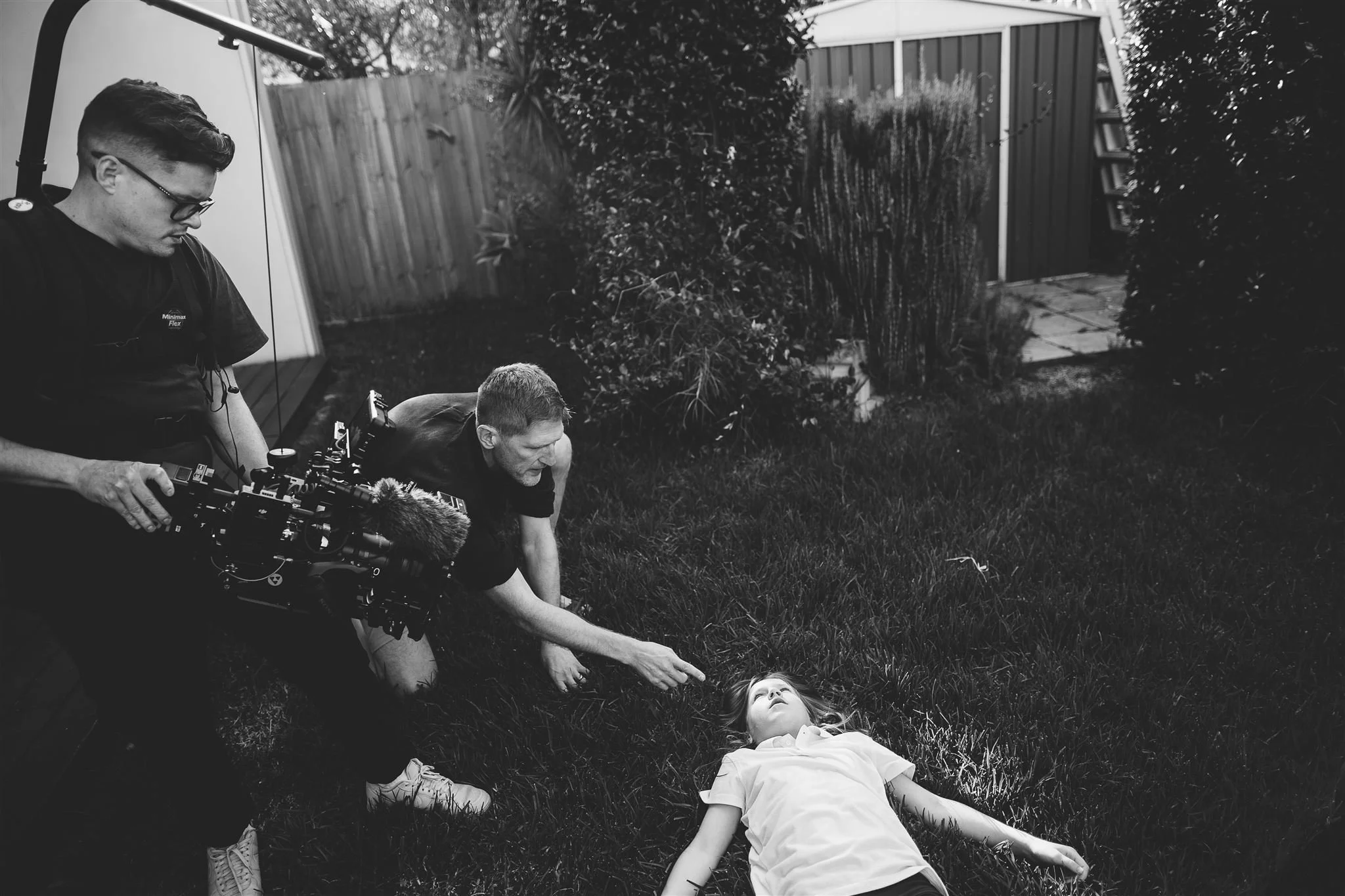 Black-and-white behind-the-scenes photo of Jerome Cole directing Things Would Be Different, with the lead actress lying on the grass during a scene.