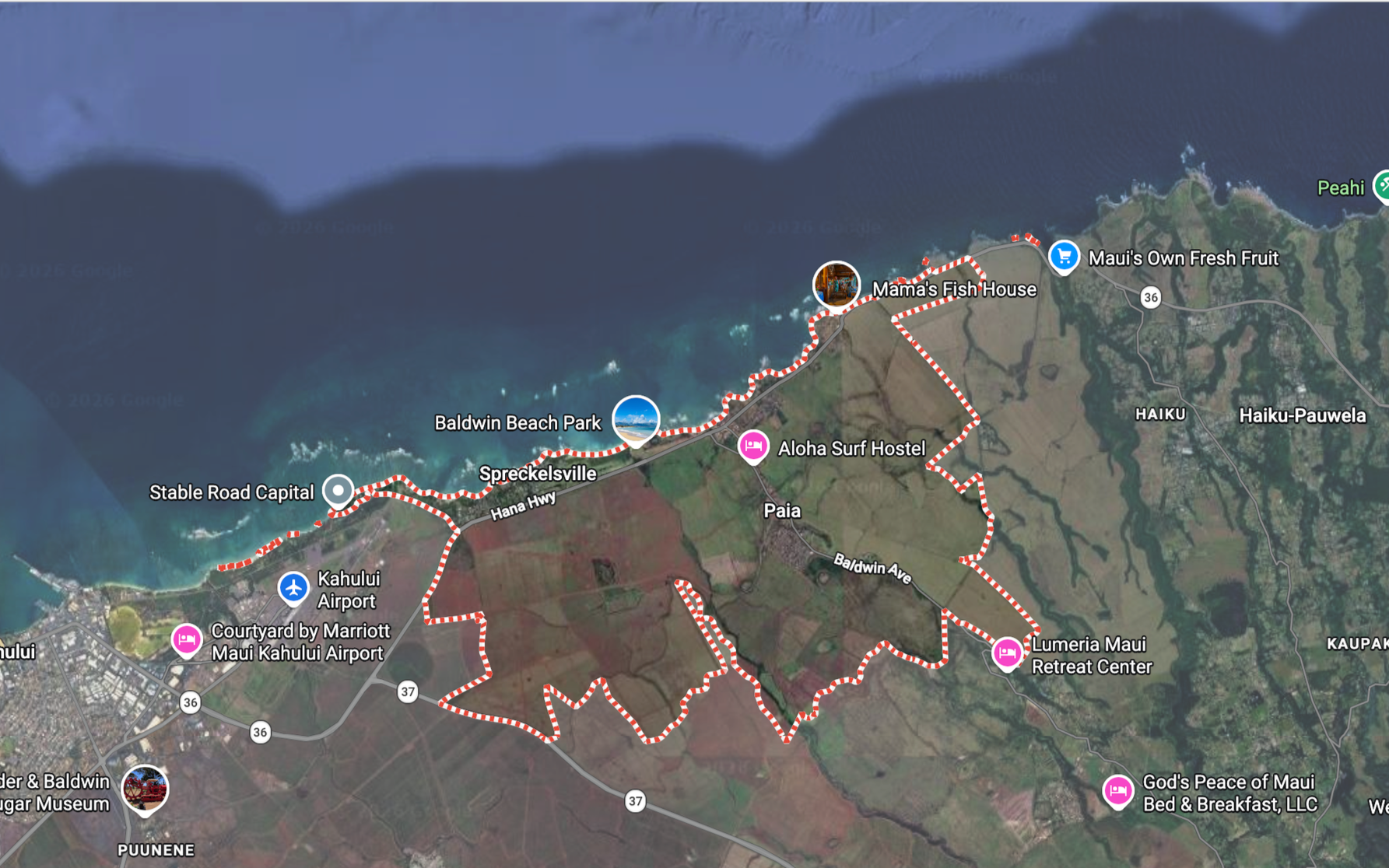Map of a coastal area with landmarks including Baldwin Beach Park, Mama's Fish House, Kahului Airport, and Maui's Own Fresh Fruit. The map features marked walking paths, roads, and points of interest like hotels and parks.