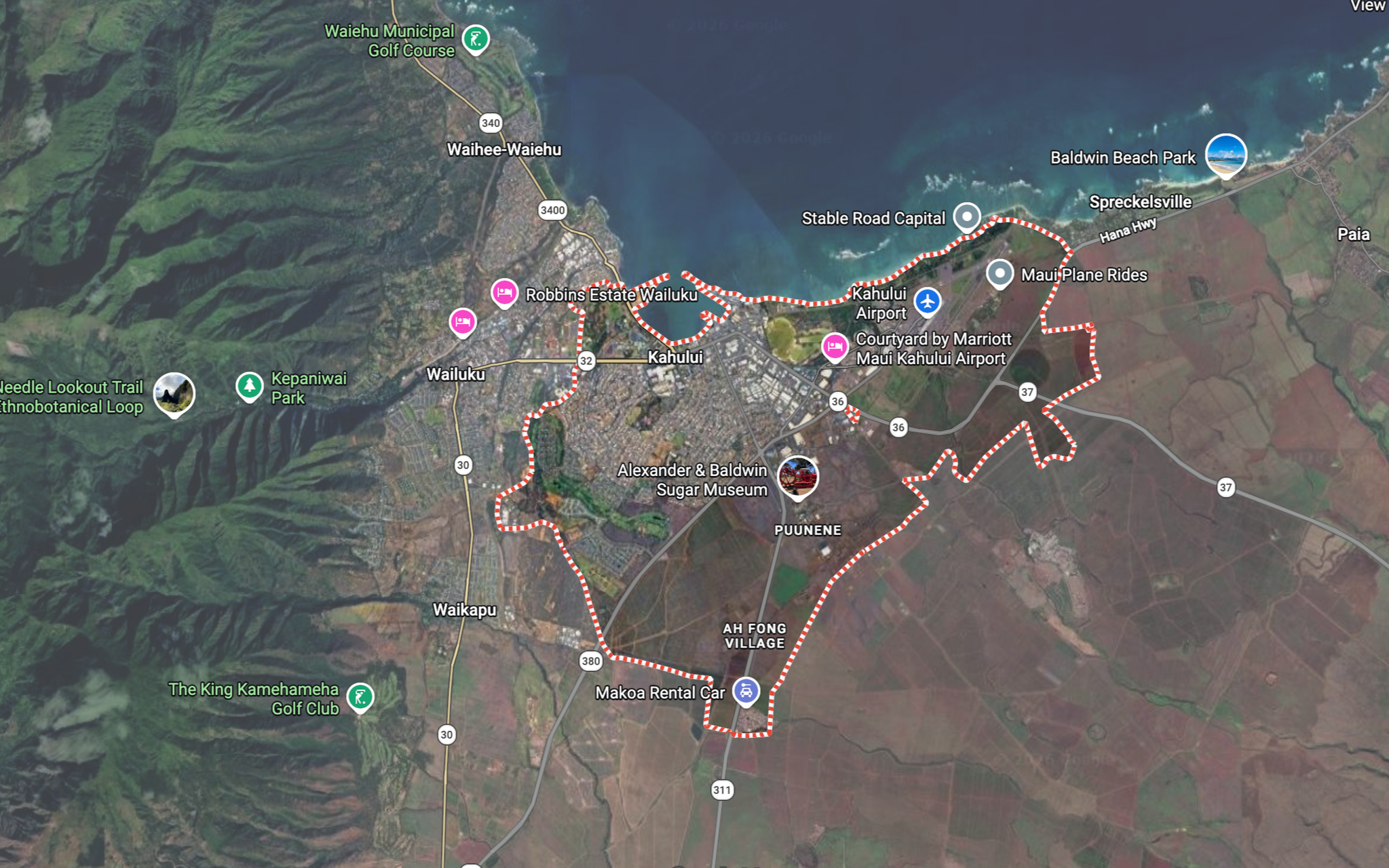 Map of Wailuku, Maui, Hawaii showing roads, parks, and landmarks including Kahului Airport, Baldwin Beach Park, and Waihee Municipal Golf Course. A red dotted trail runs through the area.