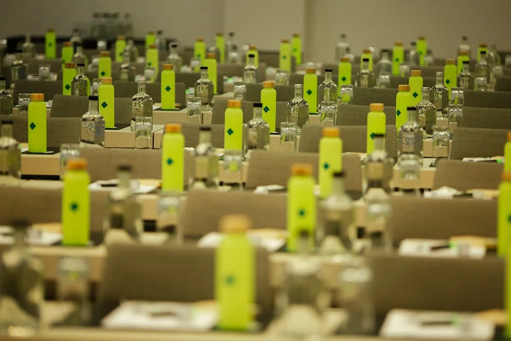 Leere Konferenzraumtische mit Wasserflaschen und Notizblöcken, bereit für ein Meeting.