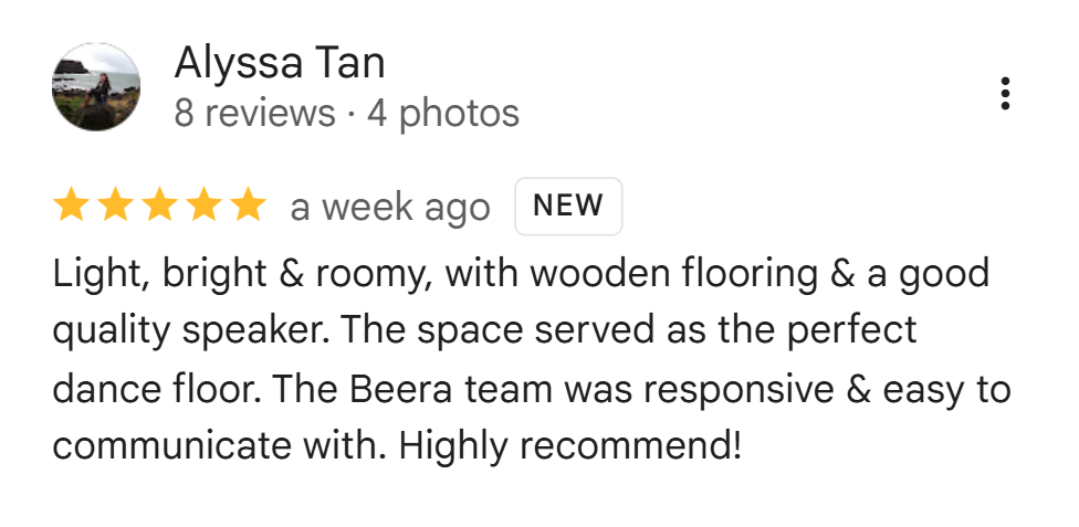 Screenshot of a review by Alyssa Tan praising a space with wooden flooring and a good quality speaker, describing it as bright, roomy, and suitable as a dance floor, with responsive staff.