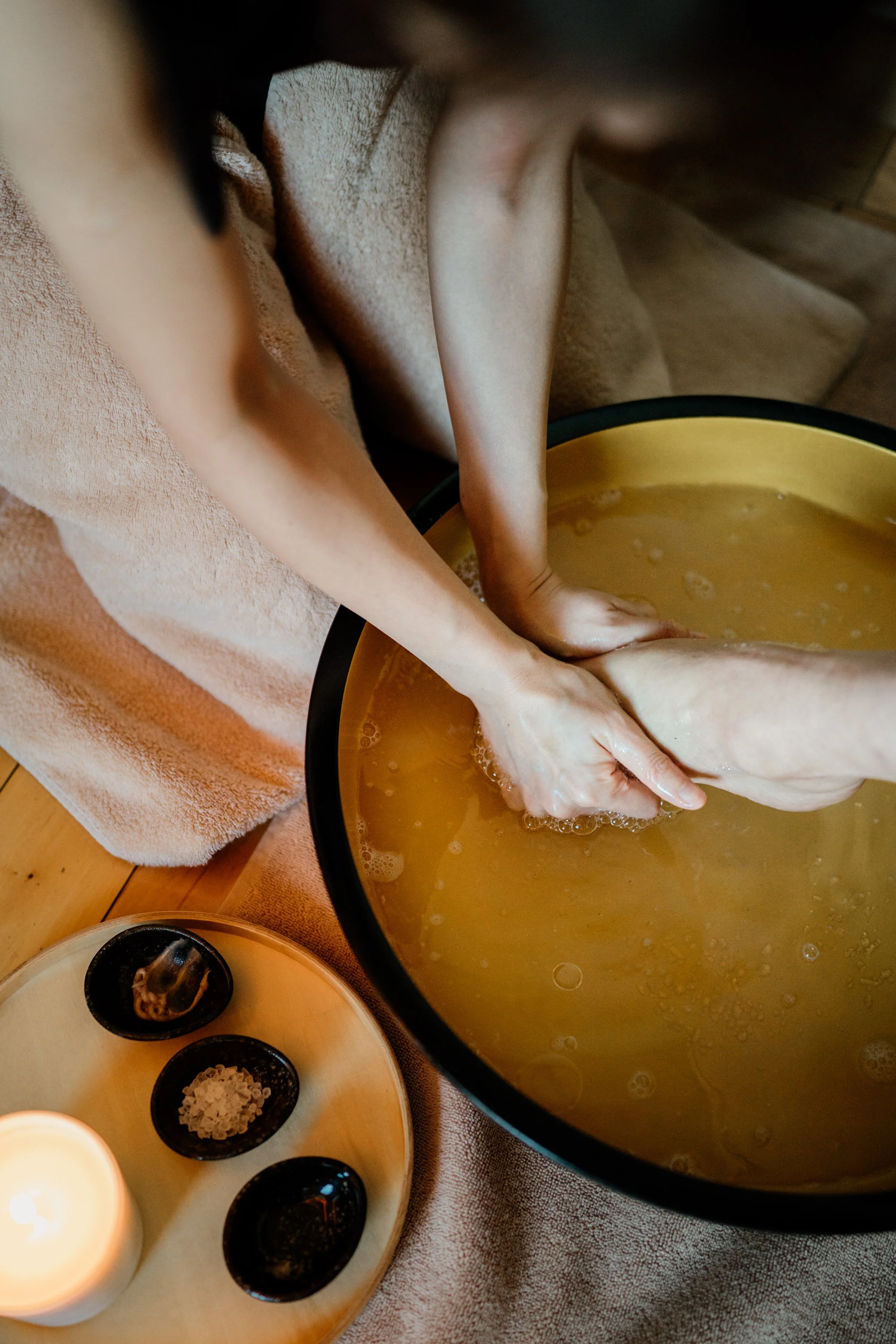 A guest enjoying spa foot soak at The Ritz-Carlton, Tokyo. Editorial hospitality photography, Japan. 