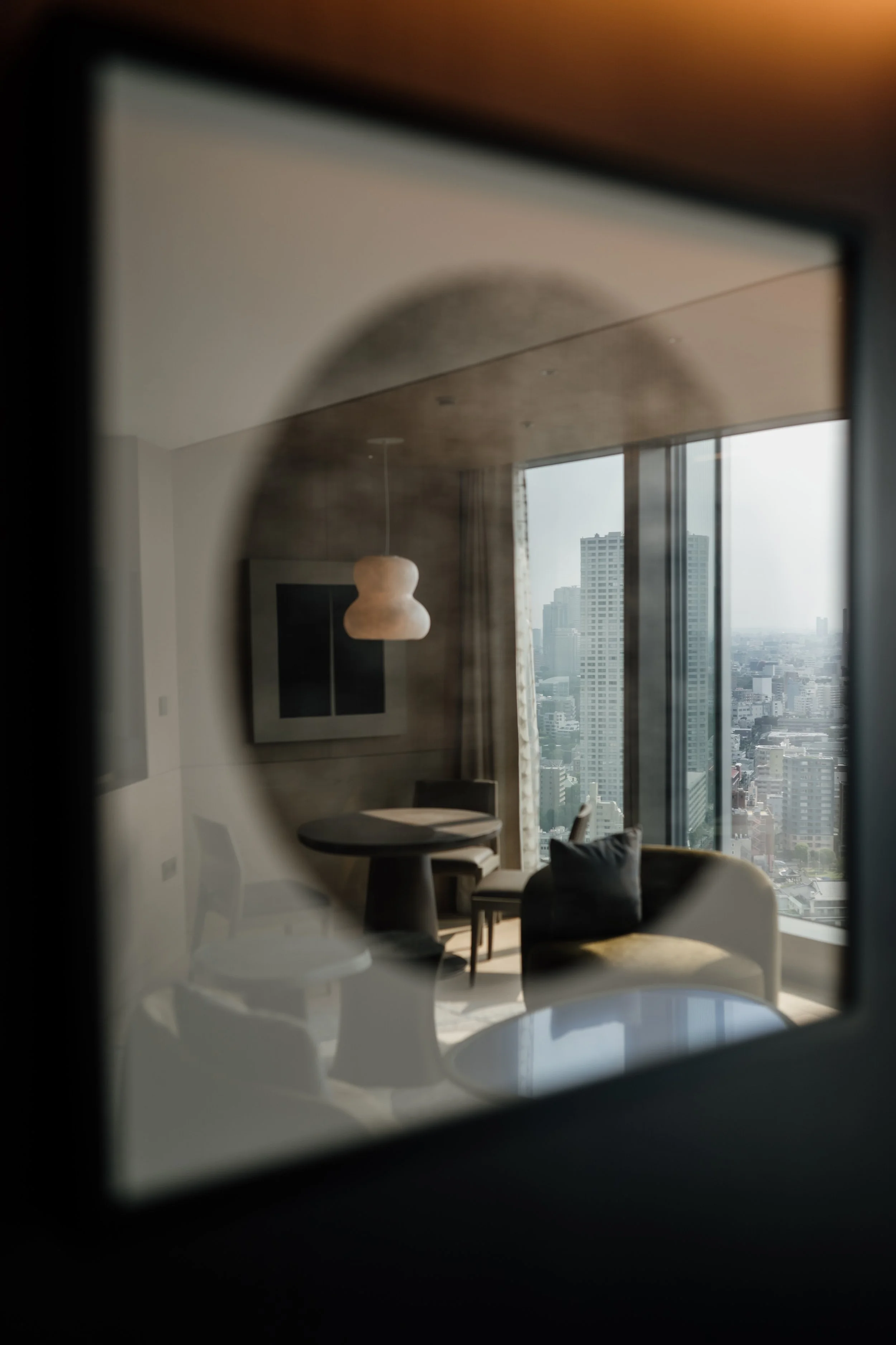 View of a modern hotel room with large windows overlooking Tokyo cityscape at JW Marriott Tokyo hotel, editorial hotel photography, Japan.