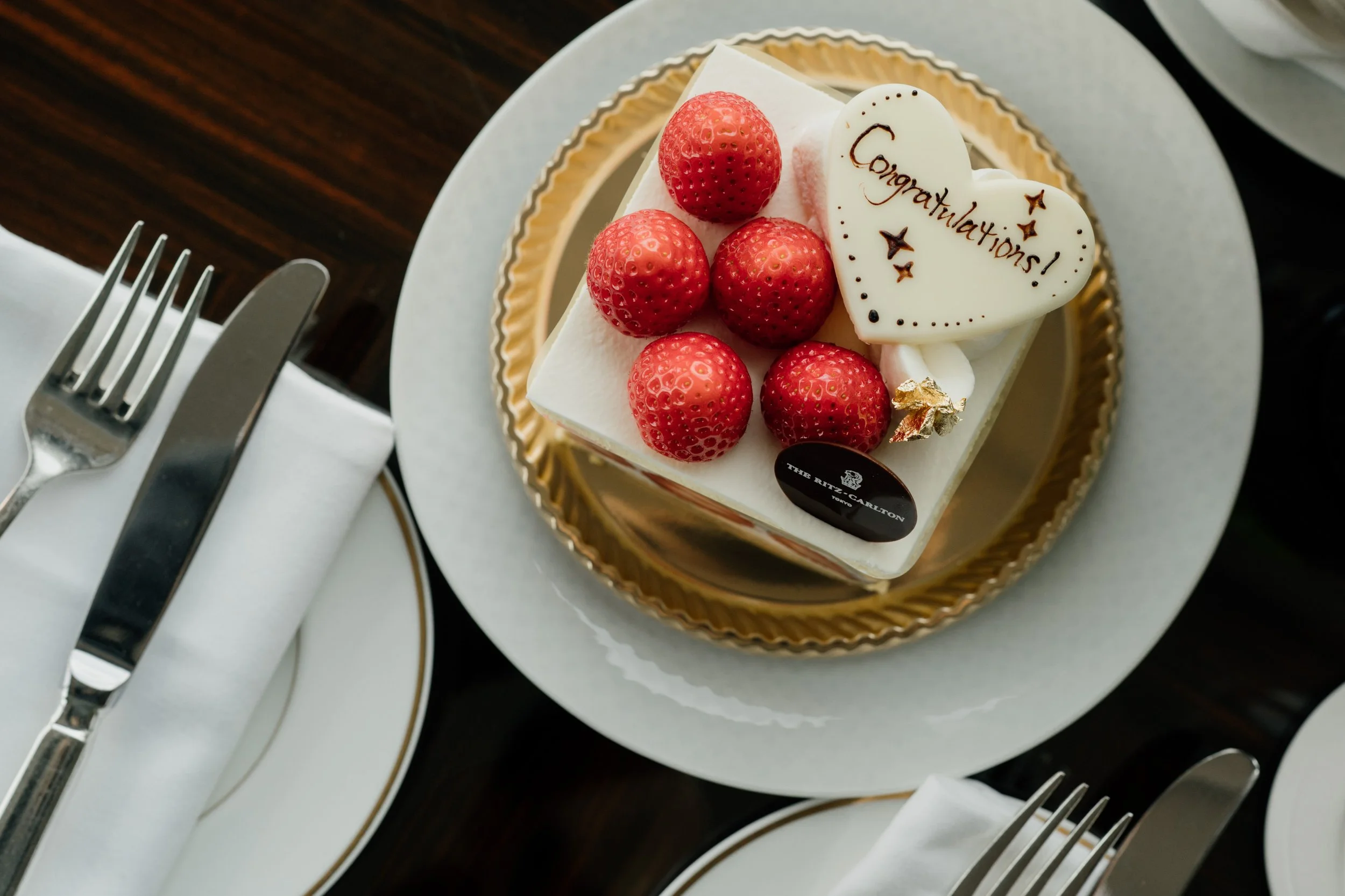 'Congratulations!' cake with Ritz-Carlton branding, hospitality, editorial photography, Japan.