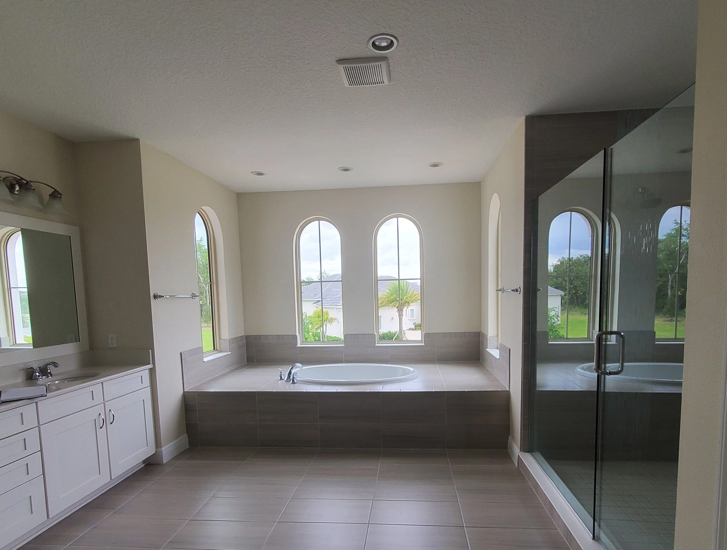 Primary bathroom before renovation, showing the original bathtub, vanity, shower and layout prior to the Studio Bortto interior design transformation.