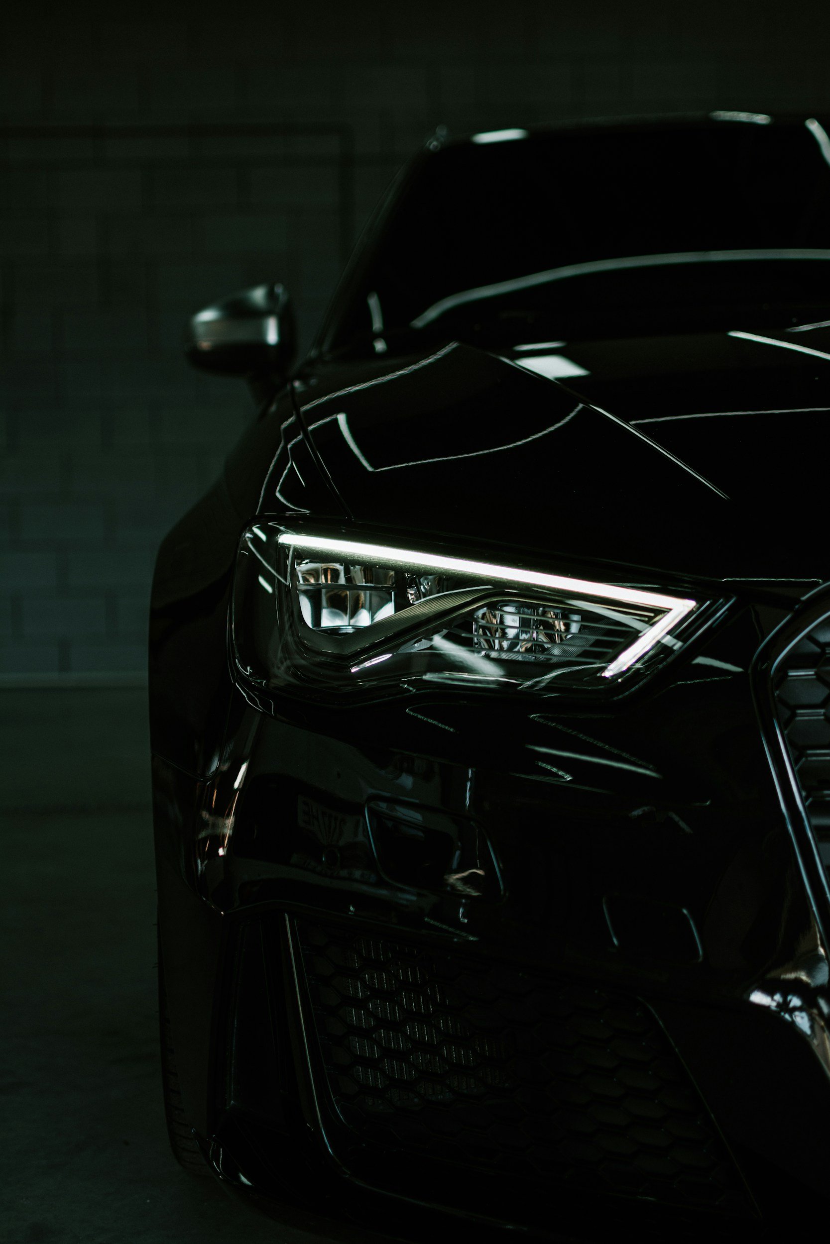 Professional paint enhancement and headlight restoration showcasing a glossy vehicle finish by Pristine AutoCare & Detailing.