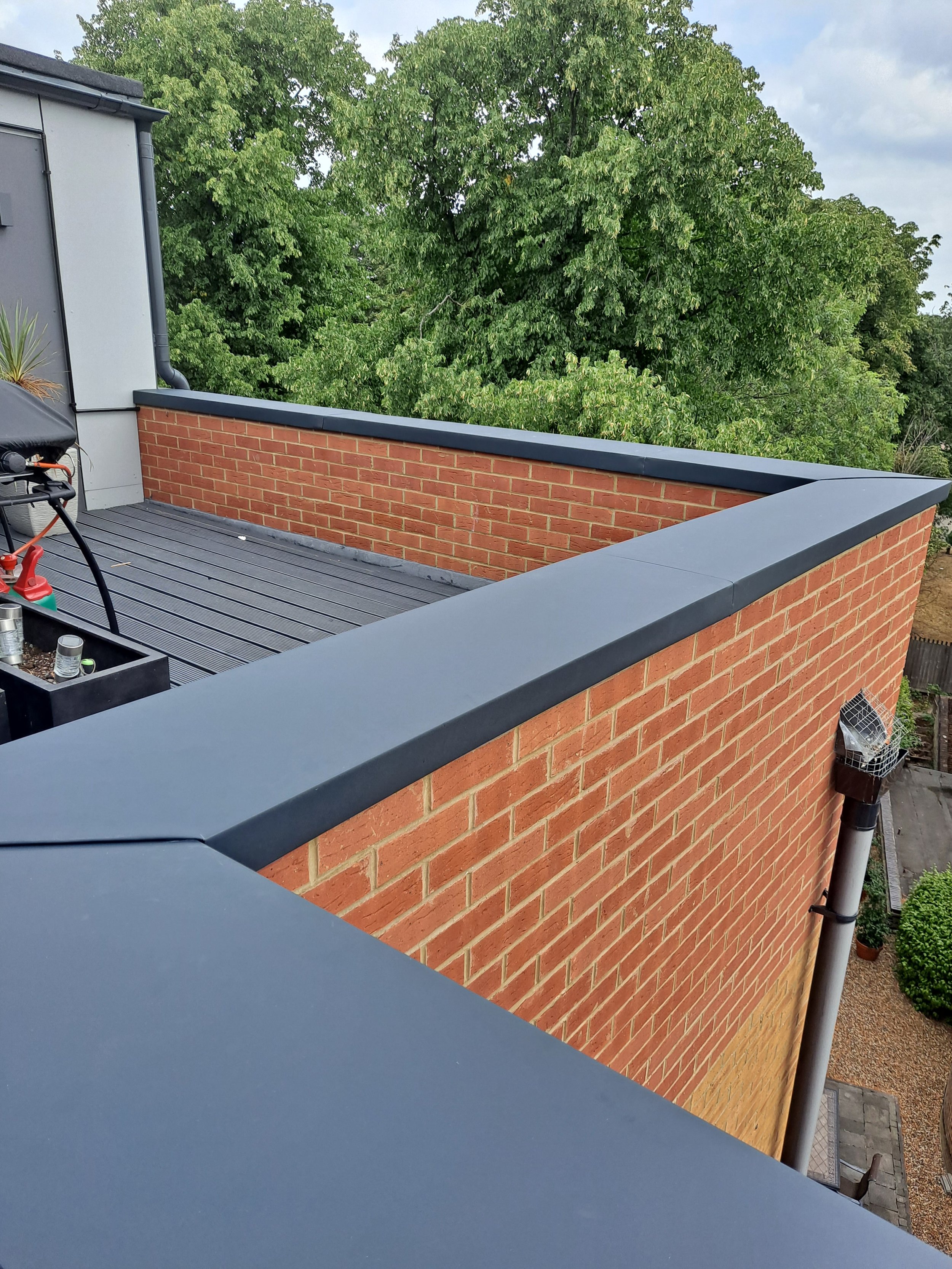 Zinc on balcony of a red brick wall.
