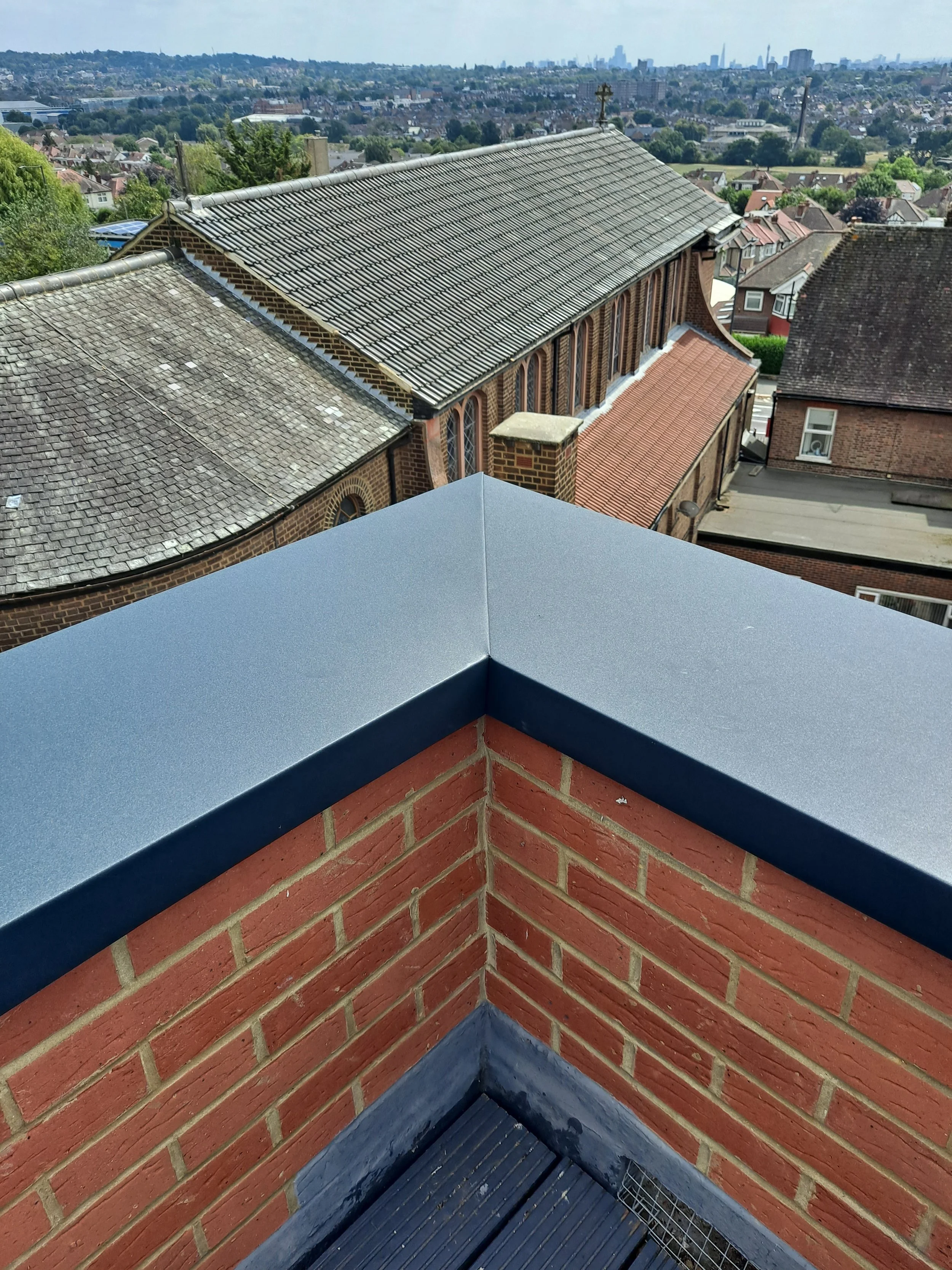 Zinc corner with a brick parapet wall.