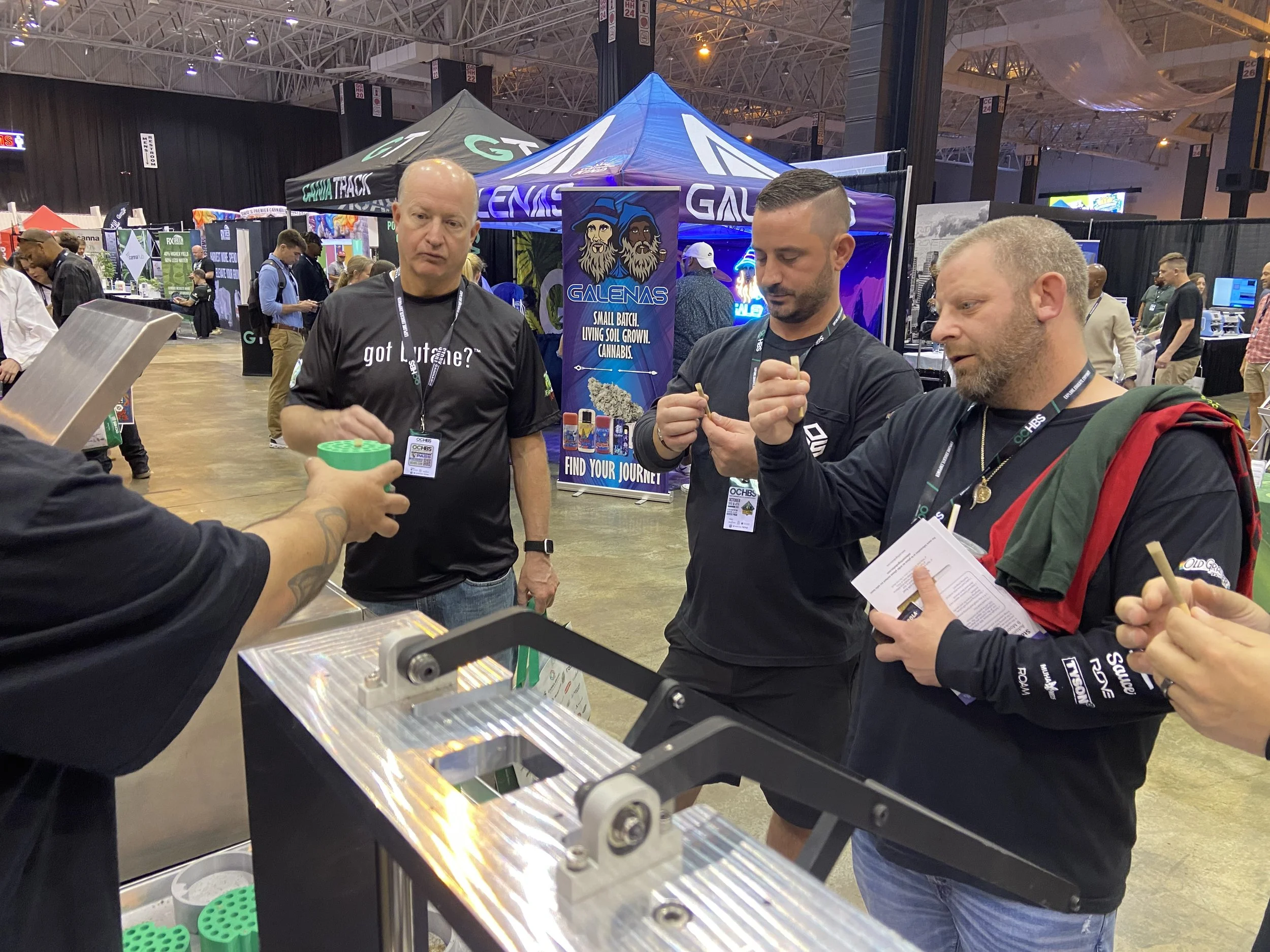 Cannabis operators reviewing Hummingbird preroll manufacturing equipment at OCHBS in Cleveland, Ohio