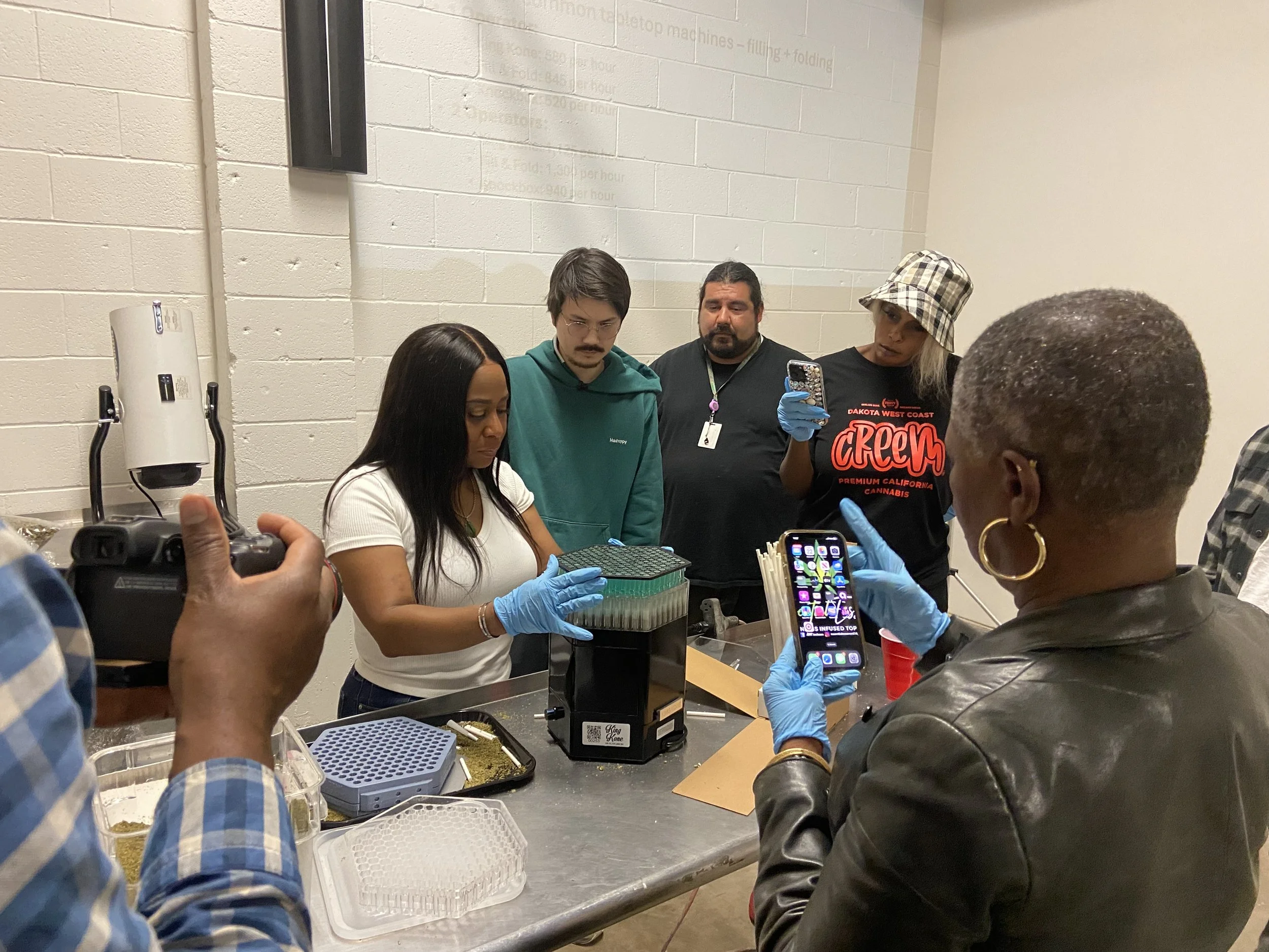 Participants watch a hands-on Hummingbird equipment demonstration at Doja Academy.