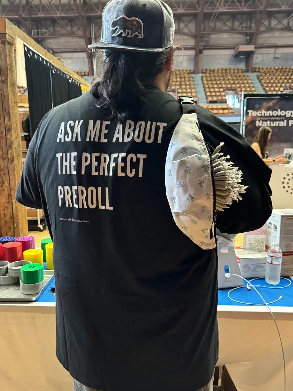 Hummingbird Preroll Systems team member carrying finished prerolls