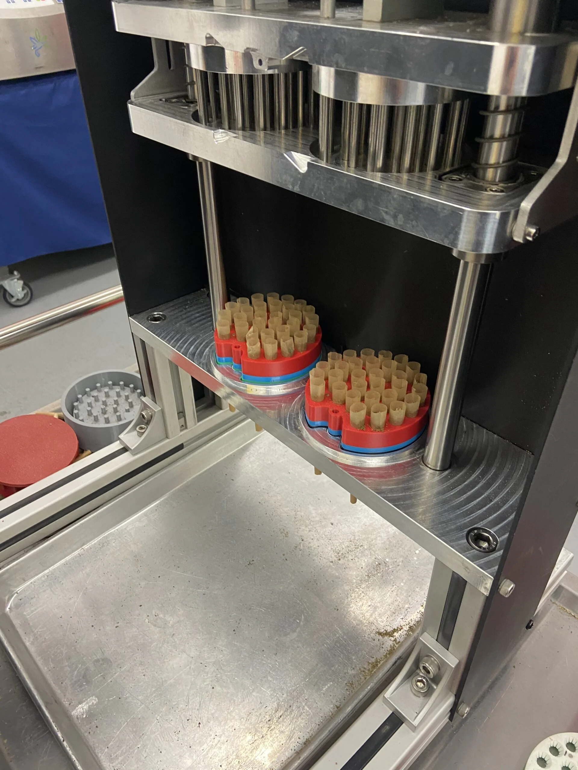 Two loaded pods positioned inside a Hummingbird Finisher beneath its closing head.