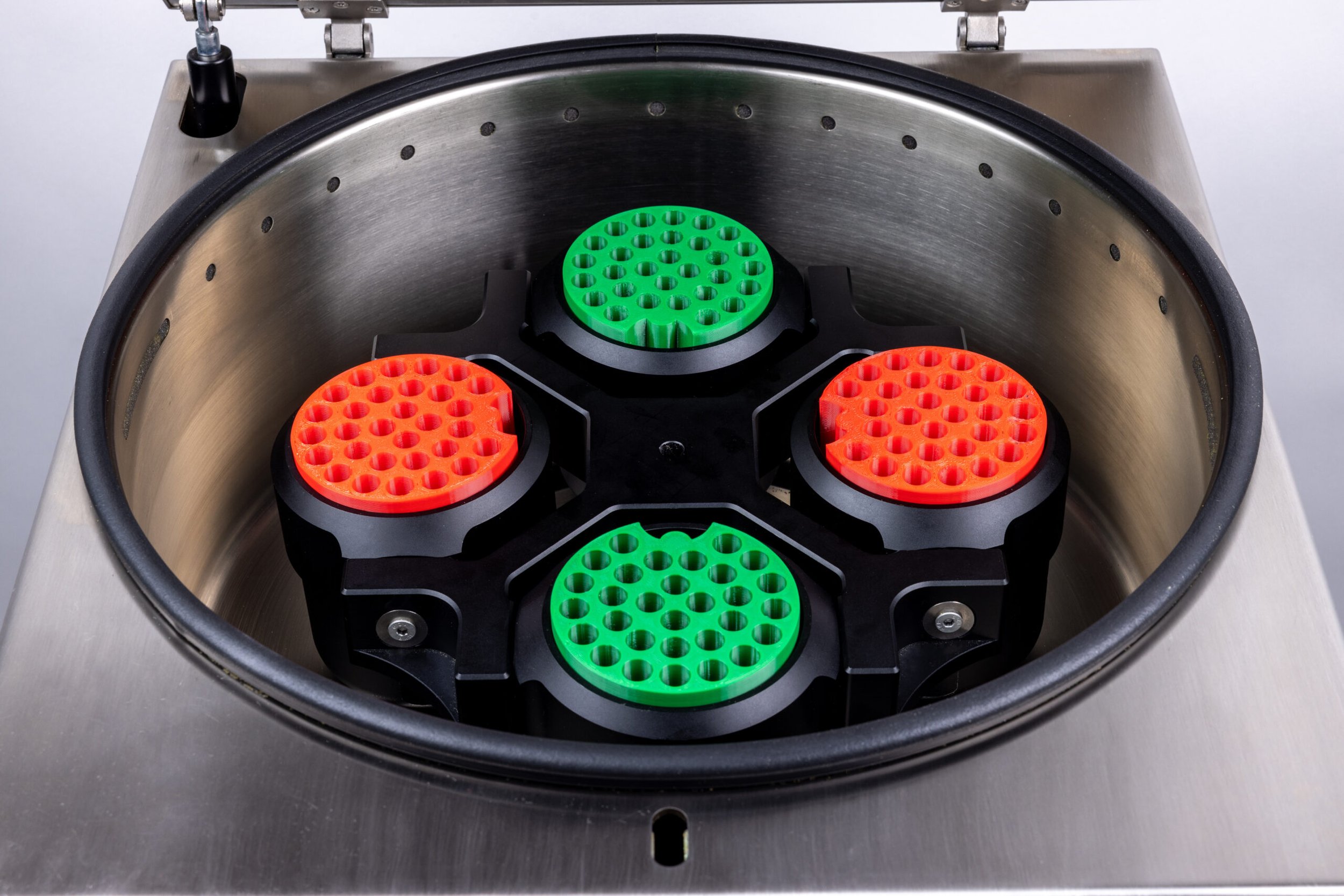 Open Hummingbird PR1 chamber with four red and green pod holders.