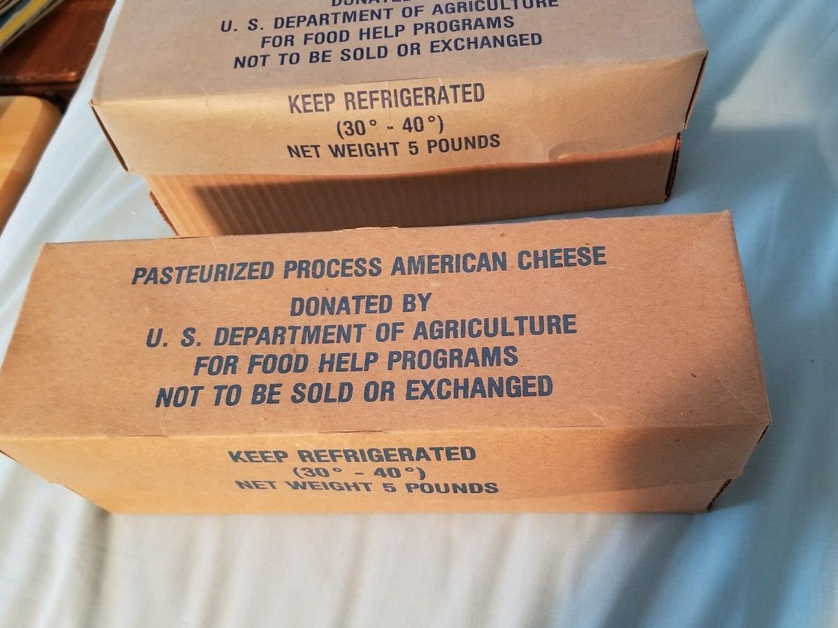 Boxes of USDA pasteurized process American cheese marked for food help programs.