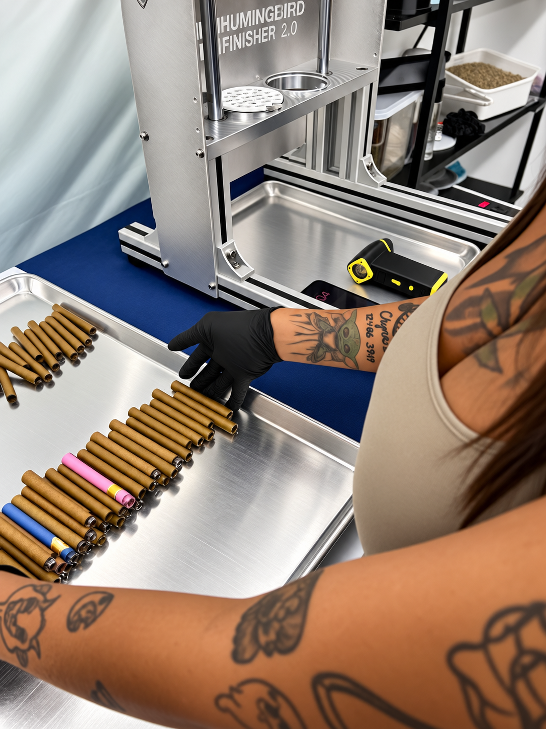 Operator loading blunt tubes into Hummingbird production equipment for automated blunt manufacturing