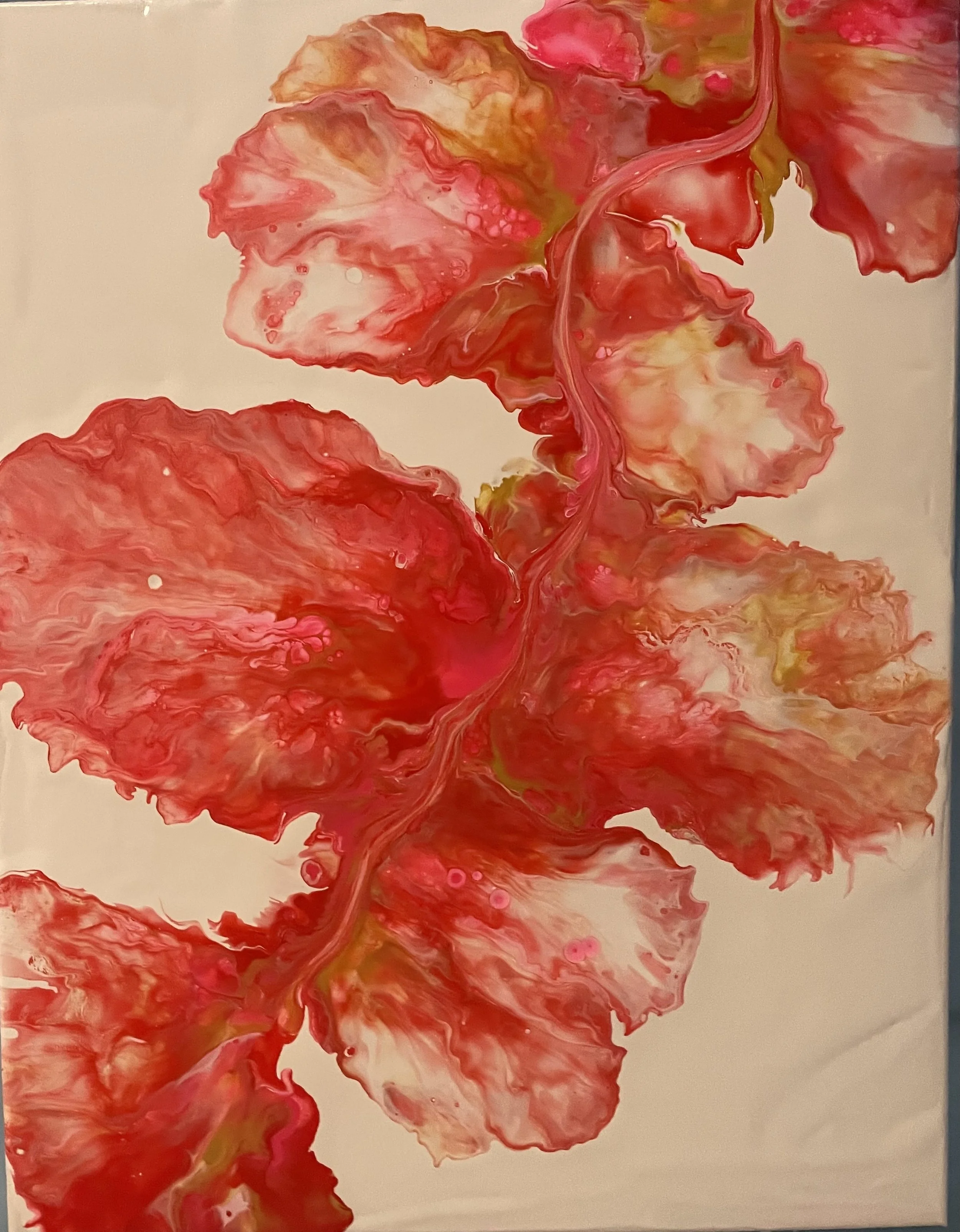 Abstract painting with swirling shades of red, pink, and yellow on a white background.