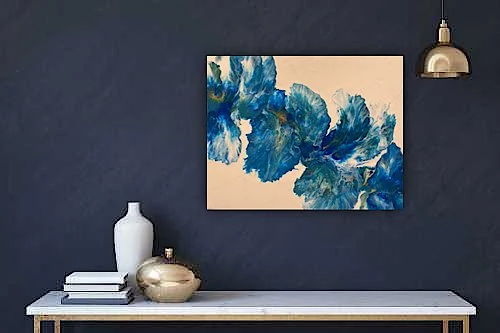 A modern interior wall with a dark blue color, featuring a large abstract painting with blue and beige tones, a white vase, a decorative gold bowl, and a gold pendant light.