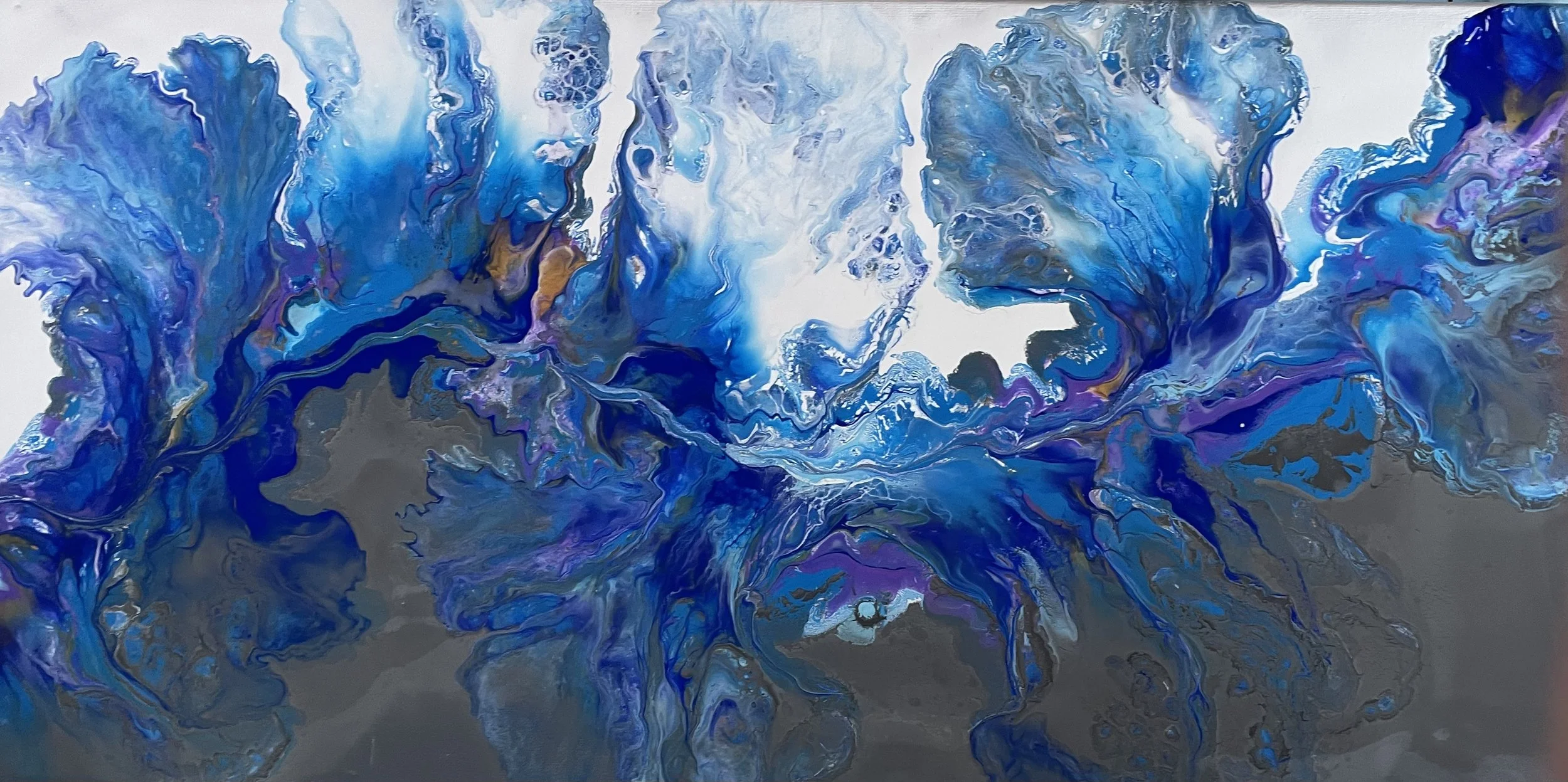 Abstract acrylic pouring artwork featuring swirling shades of blue, purple, and hints of gold on a grey background.