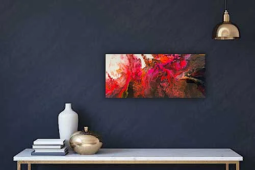 Interior wall setup with a dark blue wall, modern art painting with red and pink abstract design, white console table with decorative vases and books, and a gold pendant light.