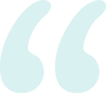 Close-up of teal quotation marks on a black background.