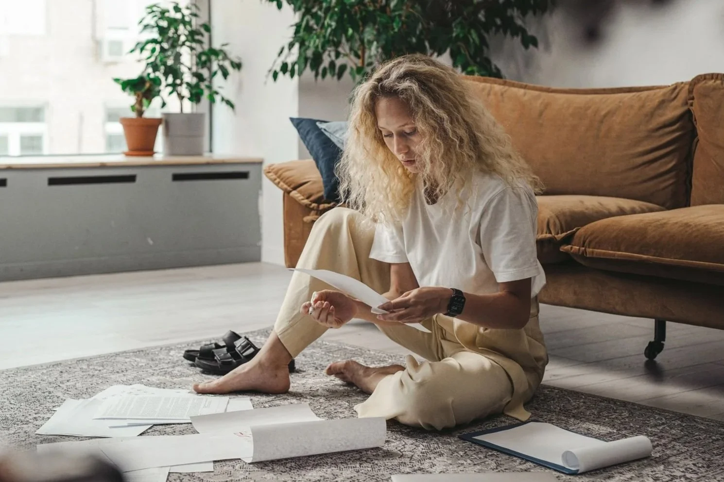 Woman sitting on the floor reviewing paperwork