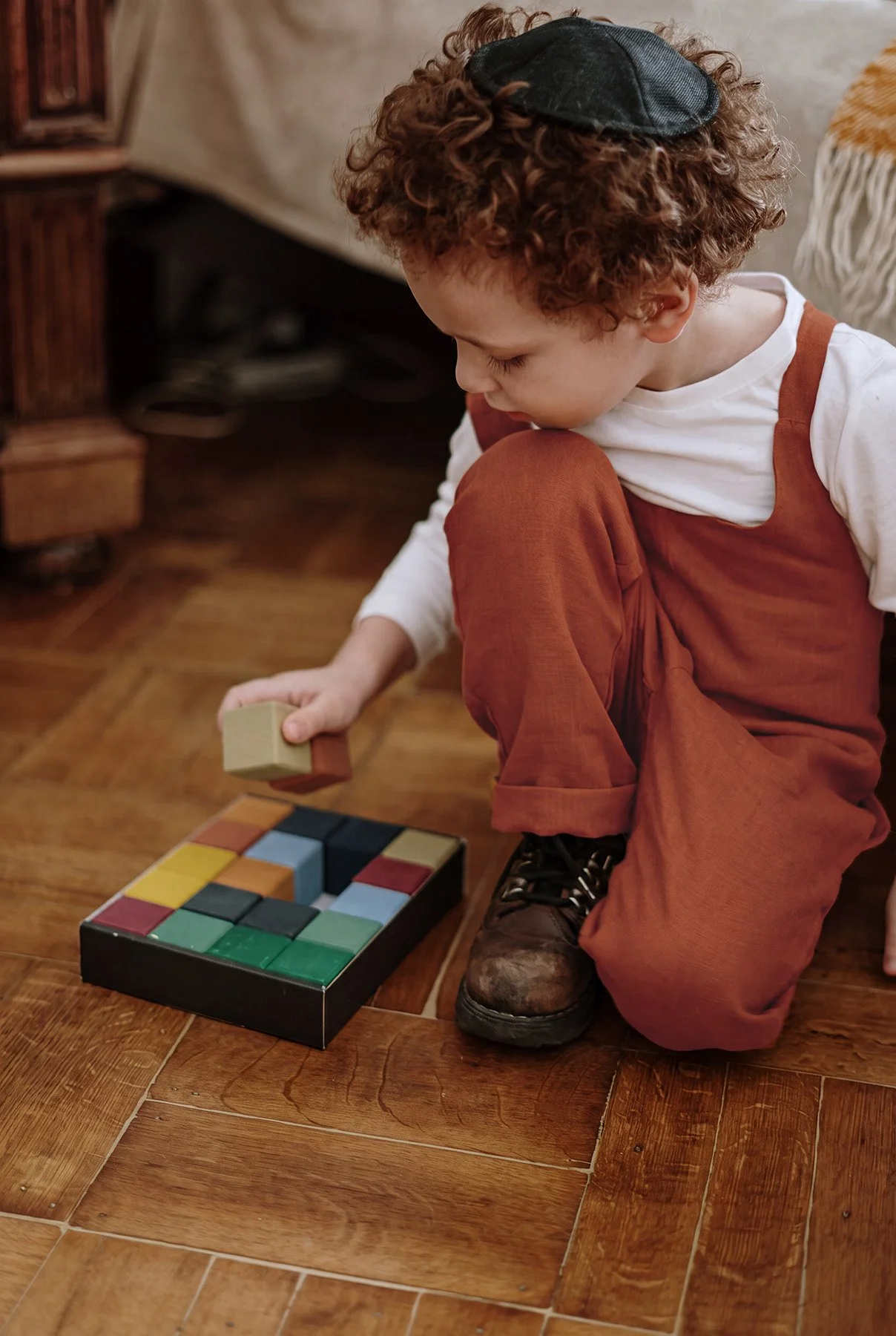 Young boy playing with colorful wooden blocks