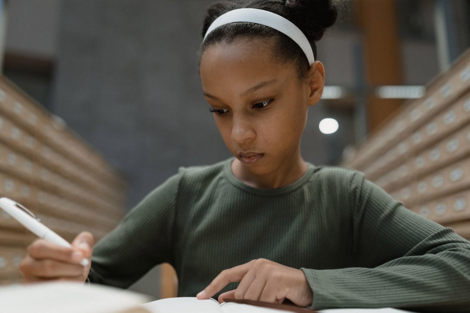 Person writing notes at a desk
